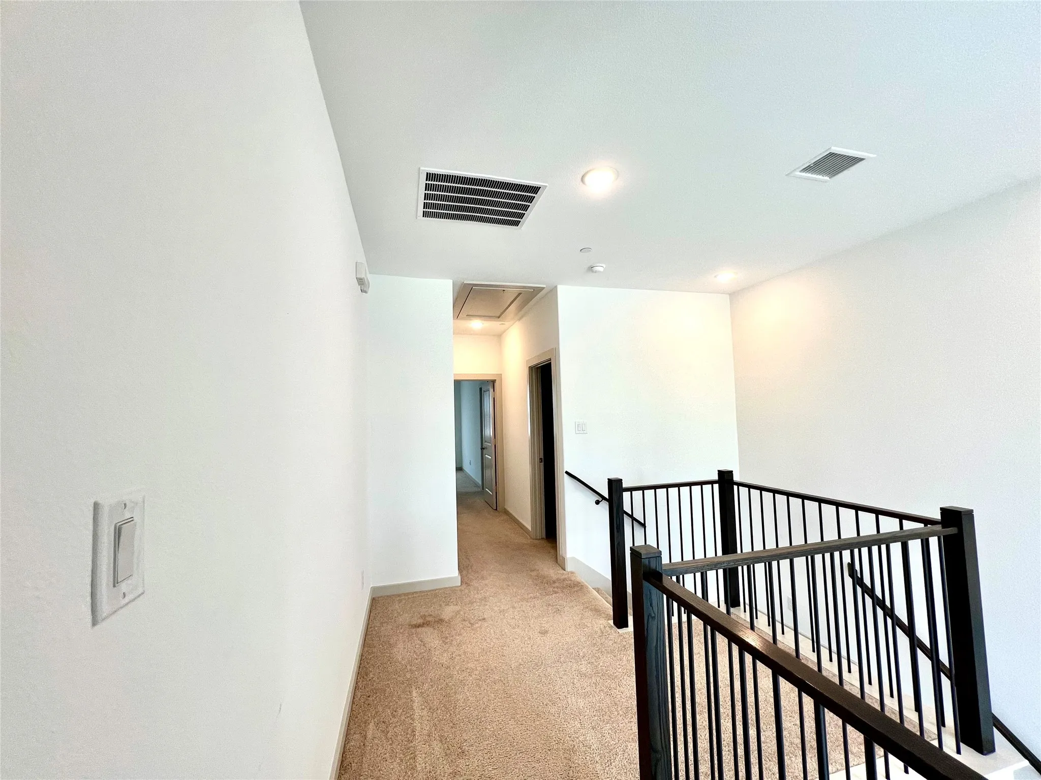 Hallway with light colored carpet