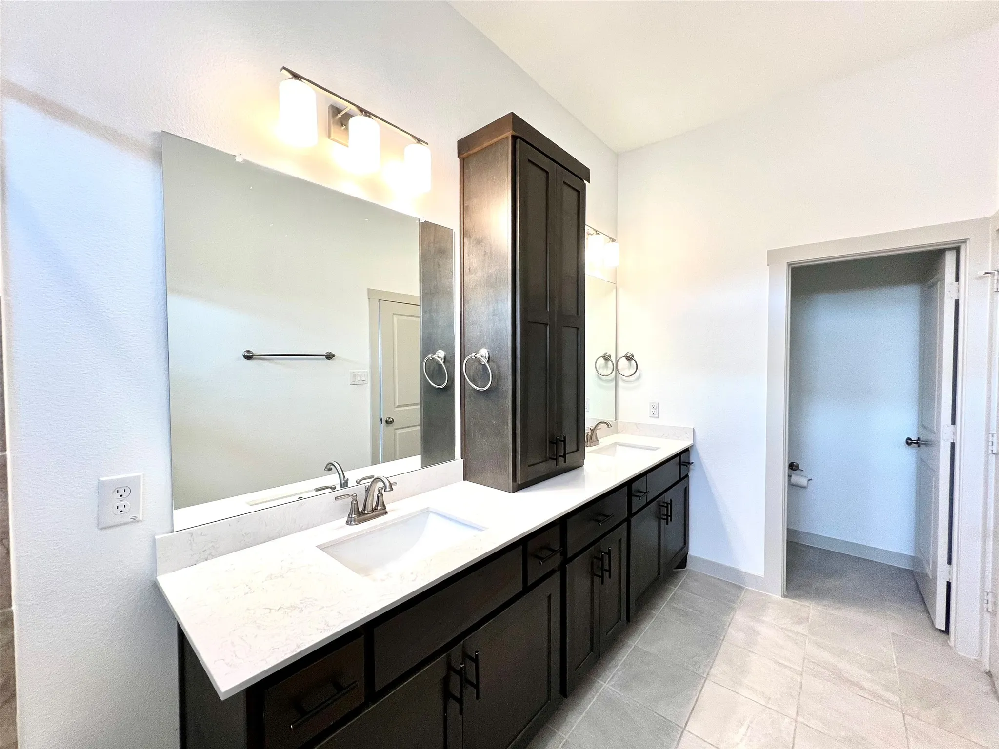 Bathroom featuring tile patterned floors and vanity