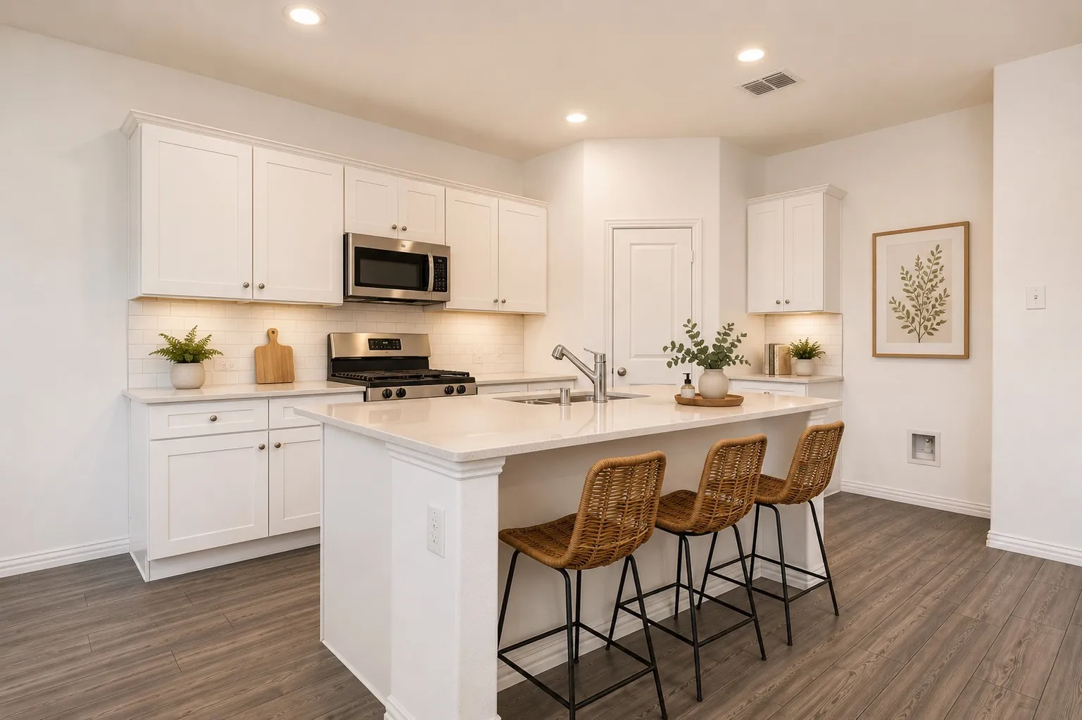 **Virtual Staged** Contemporary kitchen featuring white shaker cabinetry, stainless steel appliances, and a central island with a breakfast bar