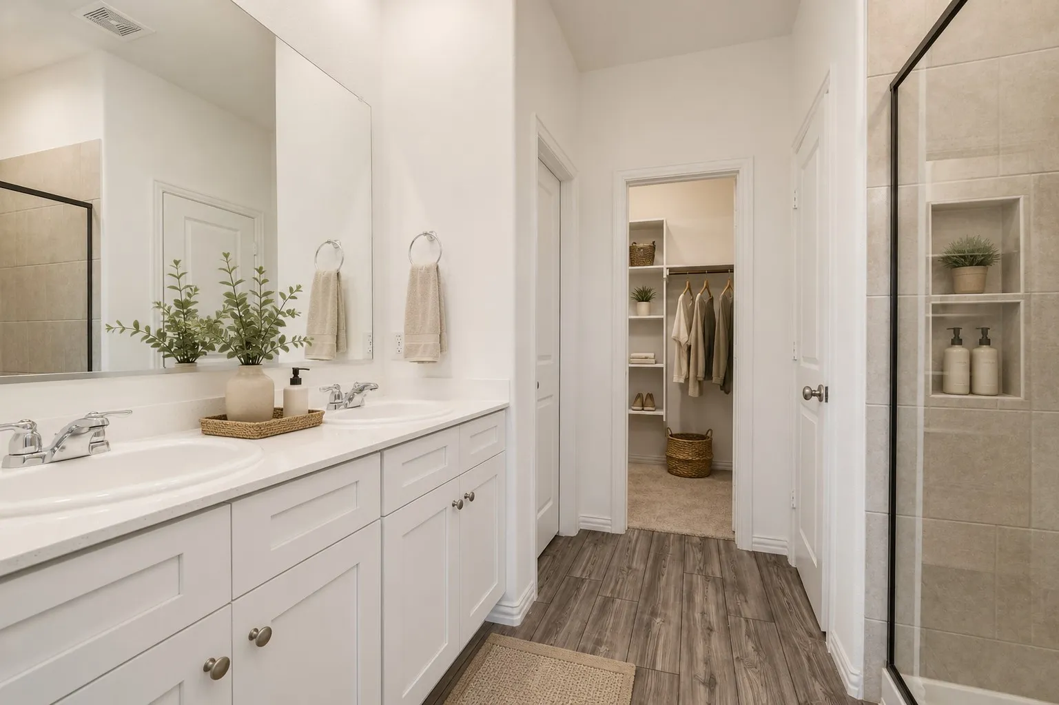 **Virtual Staged** Dual vanity with white cabinetry and integrated sinks, complemented by a large mirror