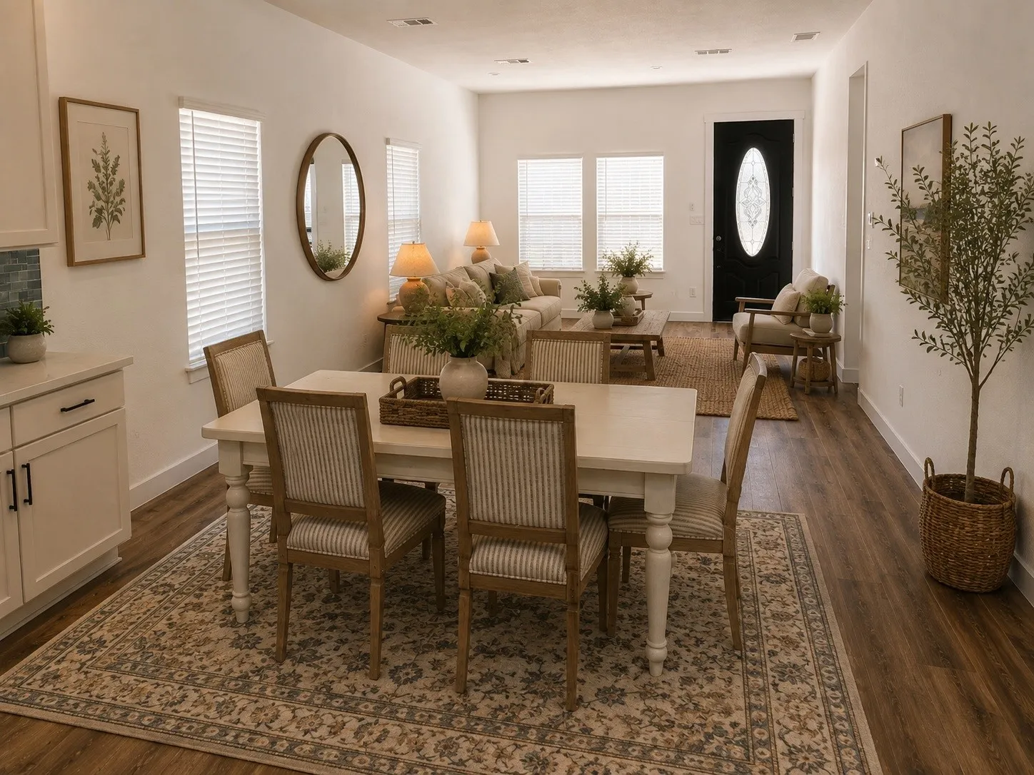 Wood-finish flooring throughout, white cabinetry with dark hardware, white walls, and multiple windows with blinds