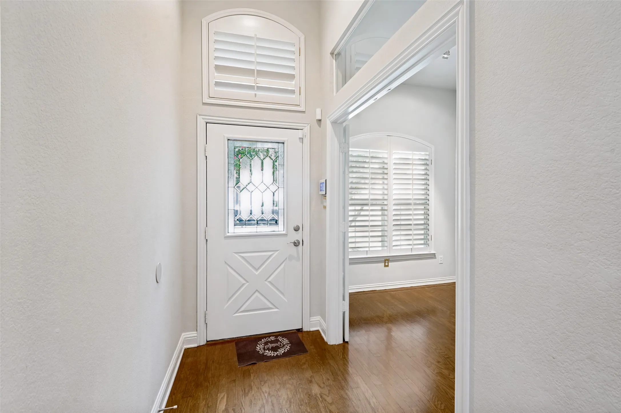 Tall ceilings and beautiful glass paneled door leads to front study room