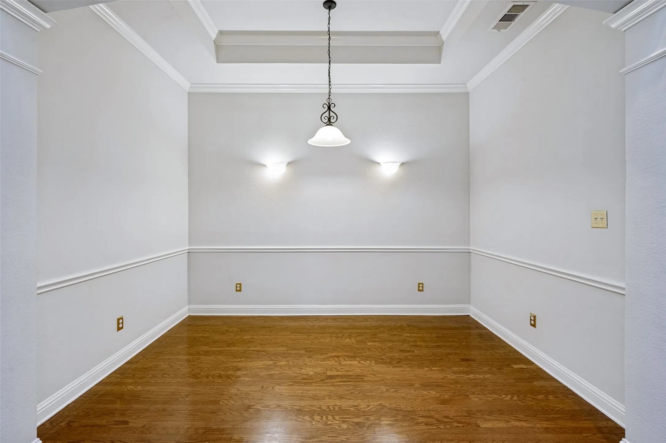 Fresh paint, gorgeous wood floors, accent lighting with wall chair railings