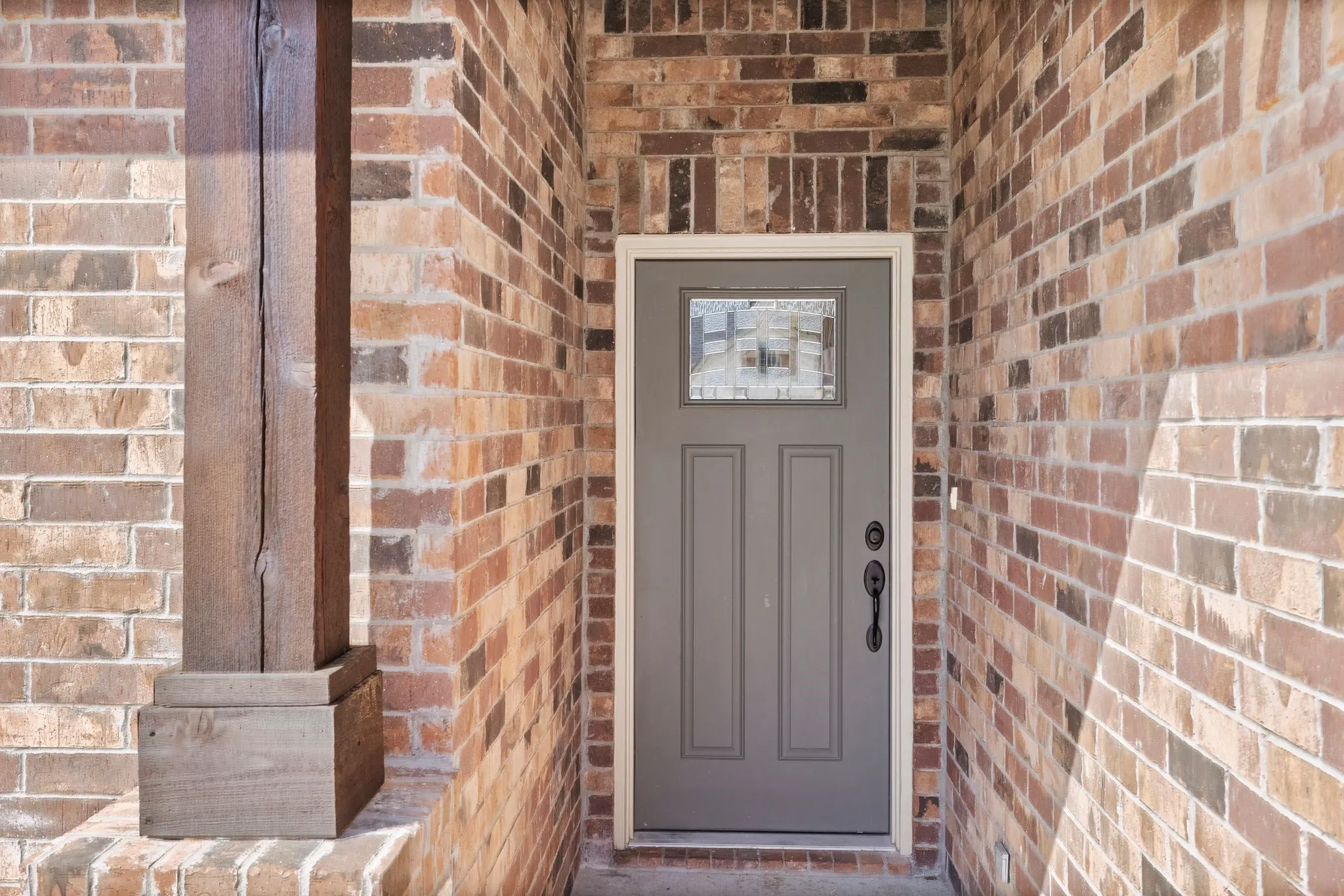 Property entrance with brick siding