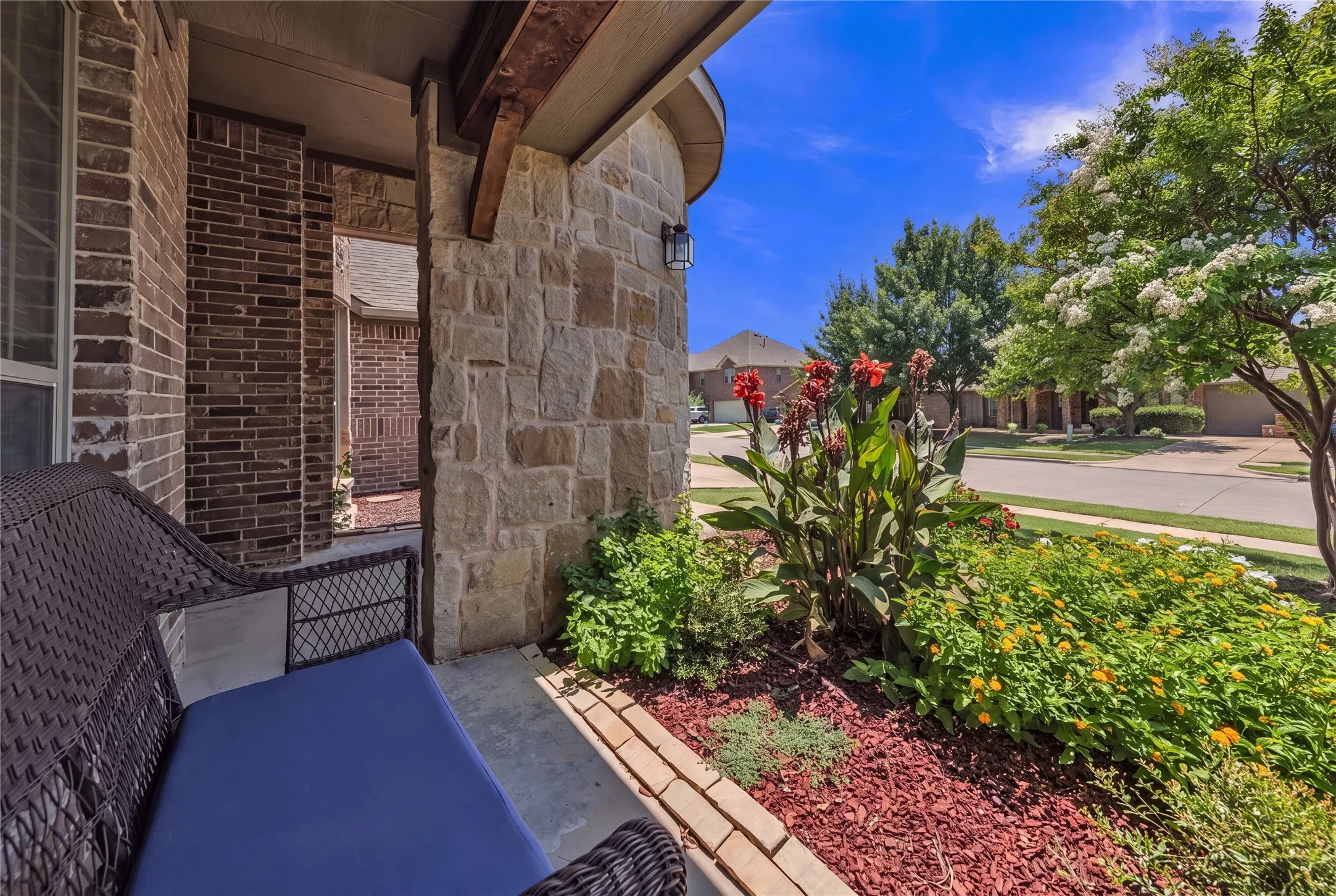 Stone and brick exterior with a covered porch entry