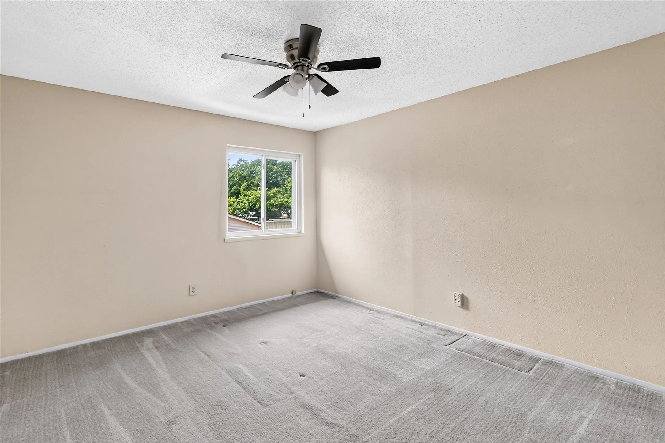 Secondary Bedroom with nice light and ceiling fan.