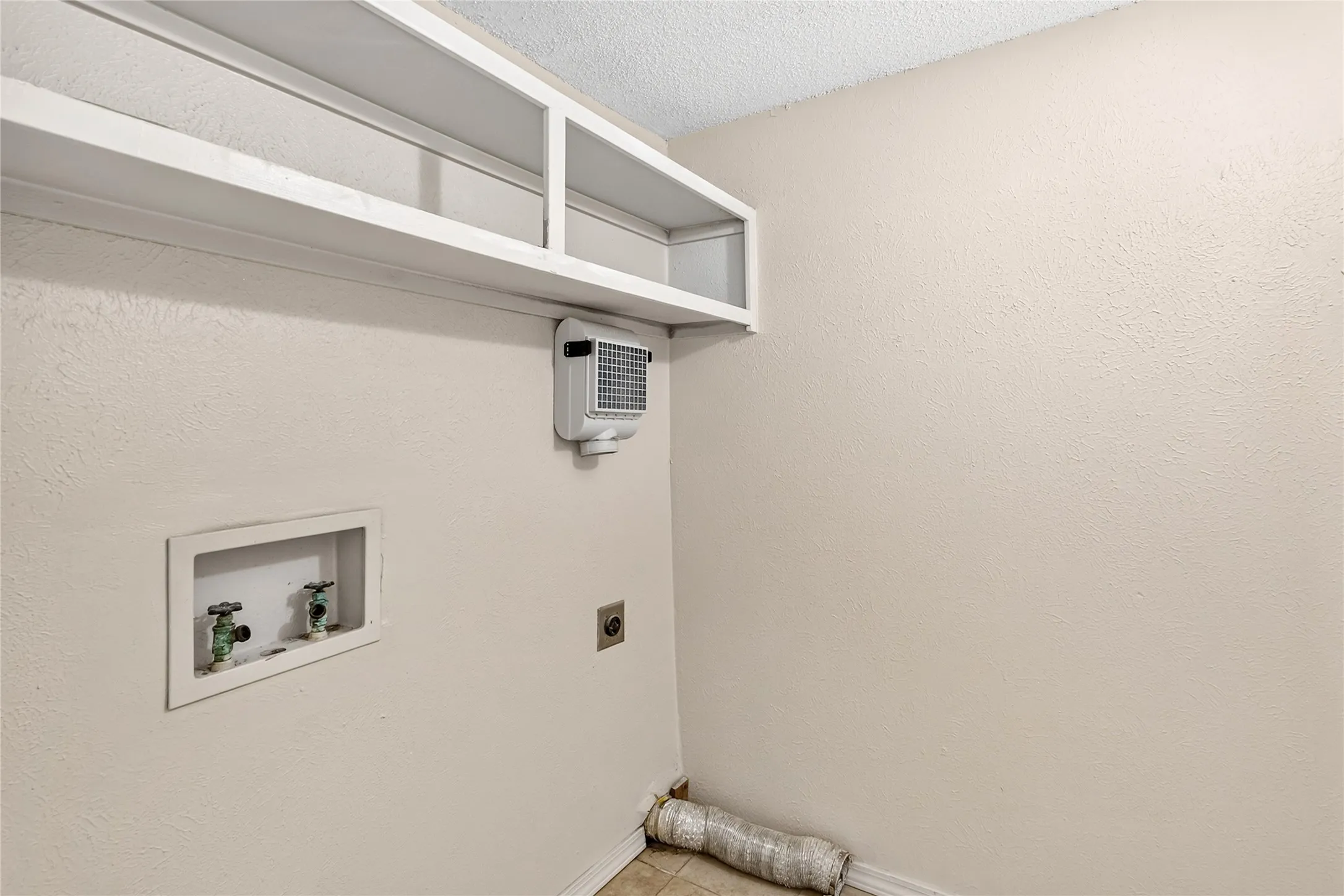 Inside laundry room just inside half bath dowstairs.