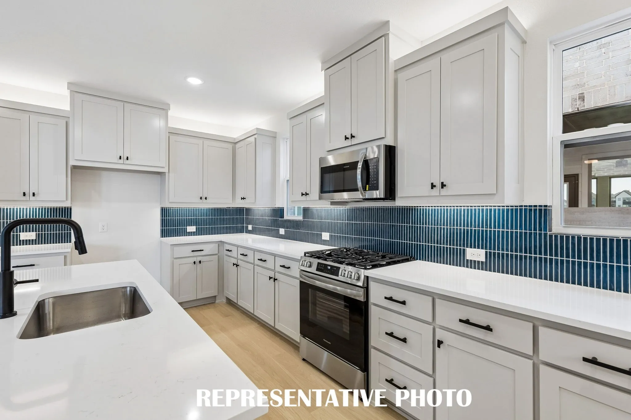 With ample cabinetry, gorgeous counter tops and designer backsplash, all the chefs in the family will love creating in this dream kitchen!  REPRESENTATIVE PHOTO