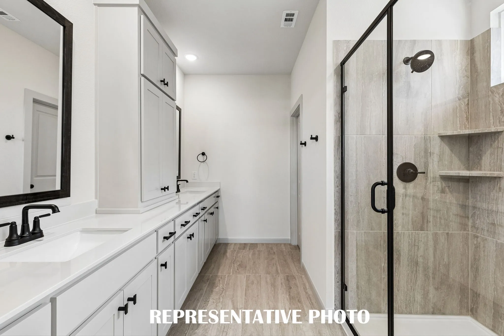 You will love the spacious walk in shower in this beautiful owner's bath.  REPRESENTATIVE PHOTO