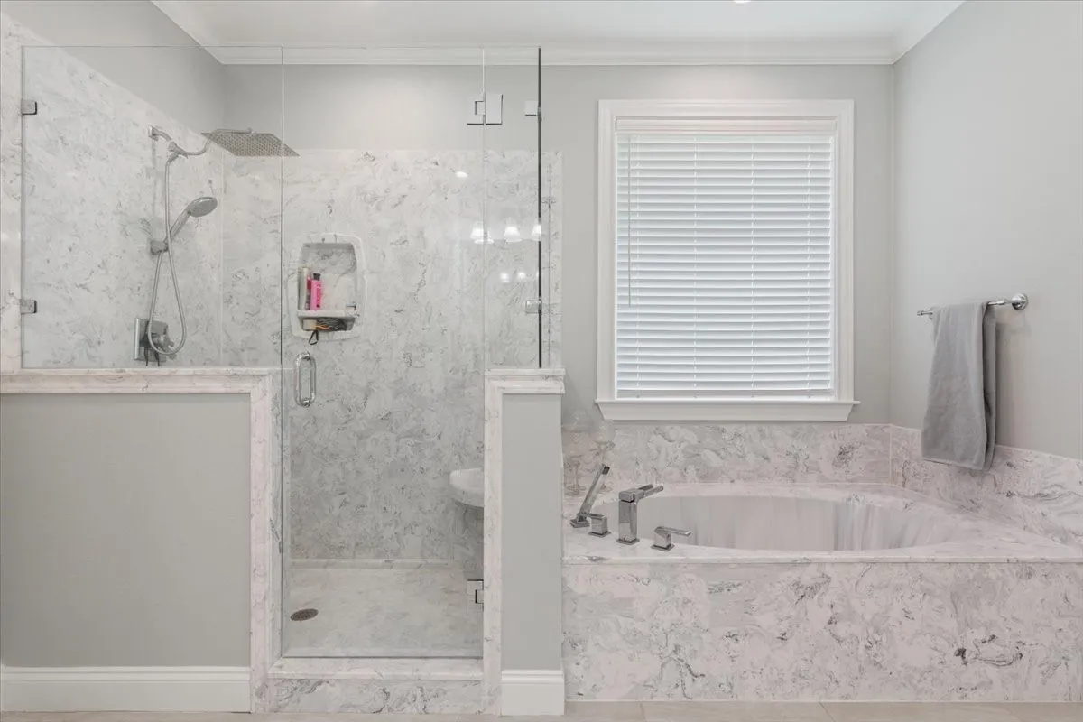 Built-in soaking tub and walk-in shower with frameless glass enclosure