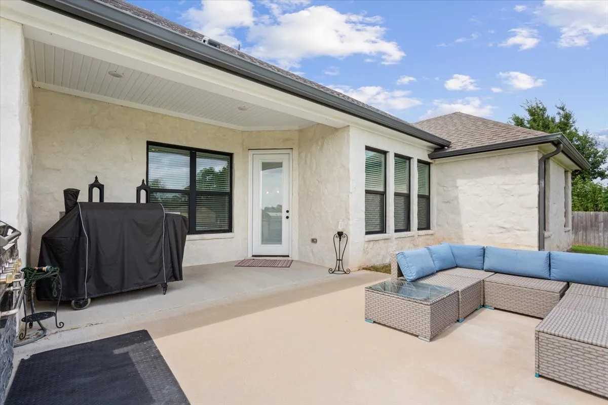 Concrete patio featuring an extended covered area with recessed lighting