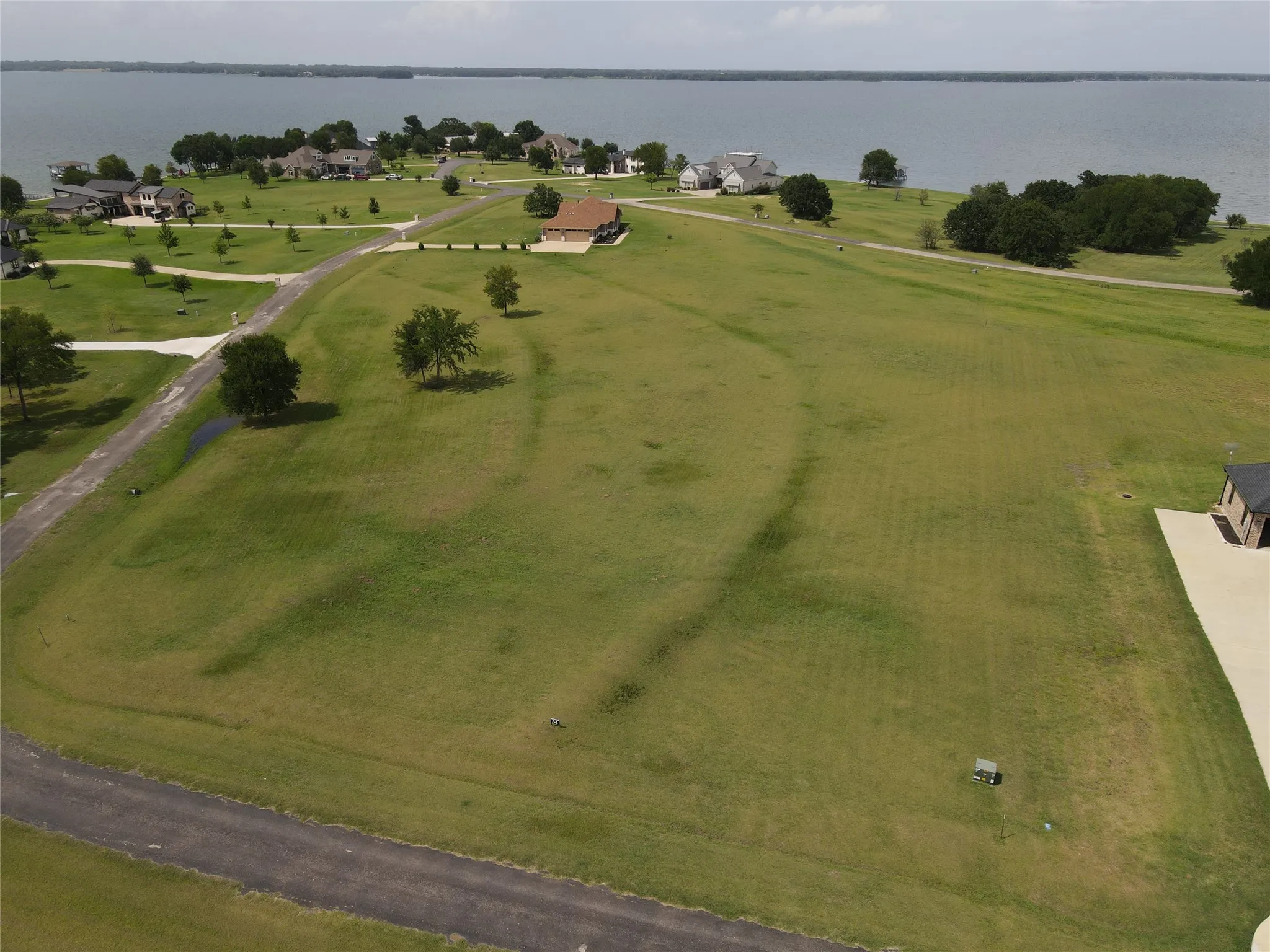 Expansive undeveloped land parcel featuring a paved road frontage