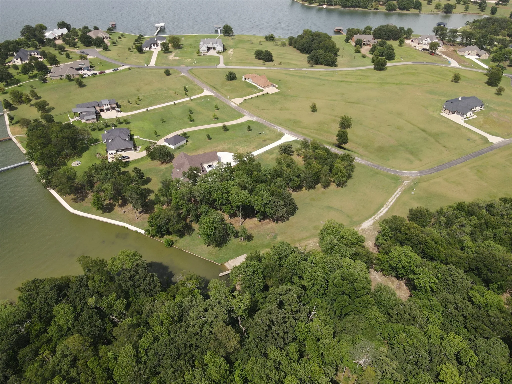 Aerial presentation of a waterfront neighborhood featuring multiple properties