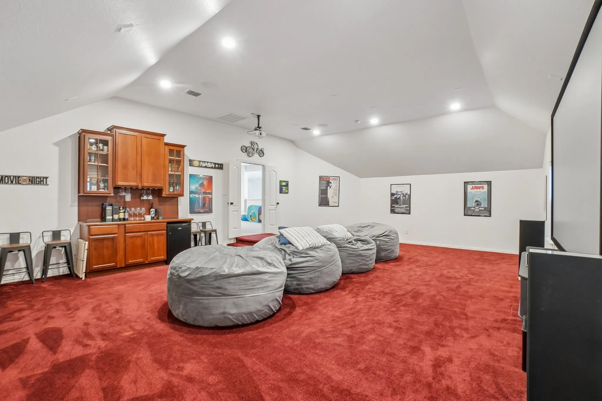 Media room with built-in cabinets fridge