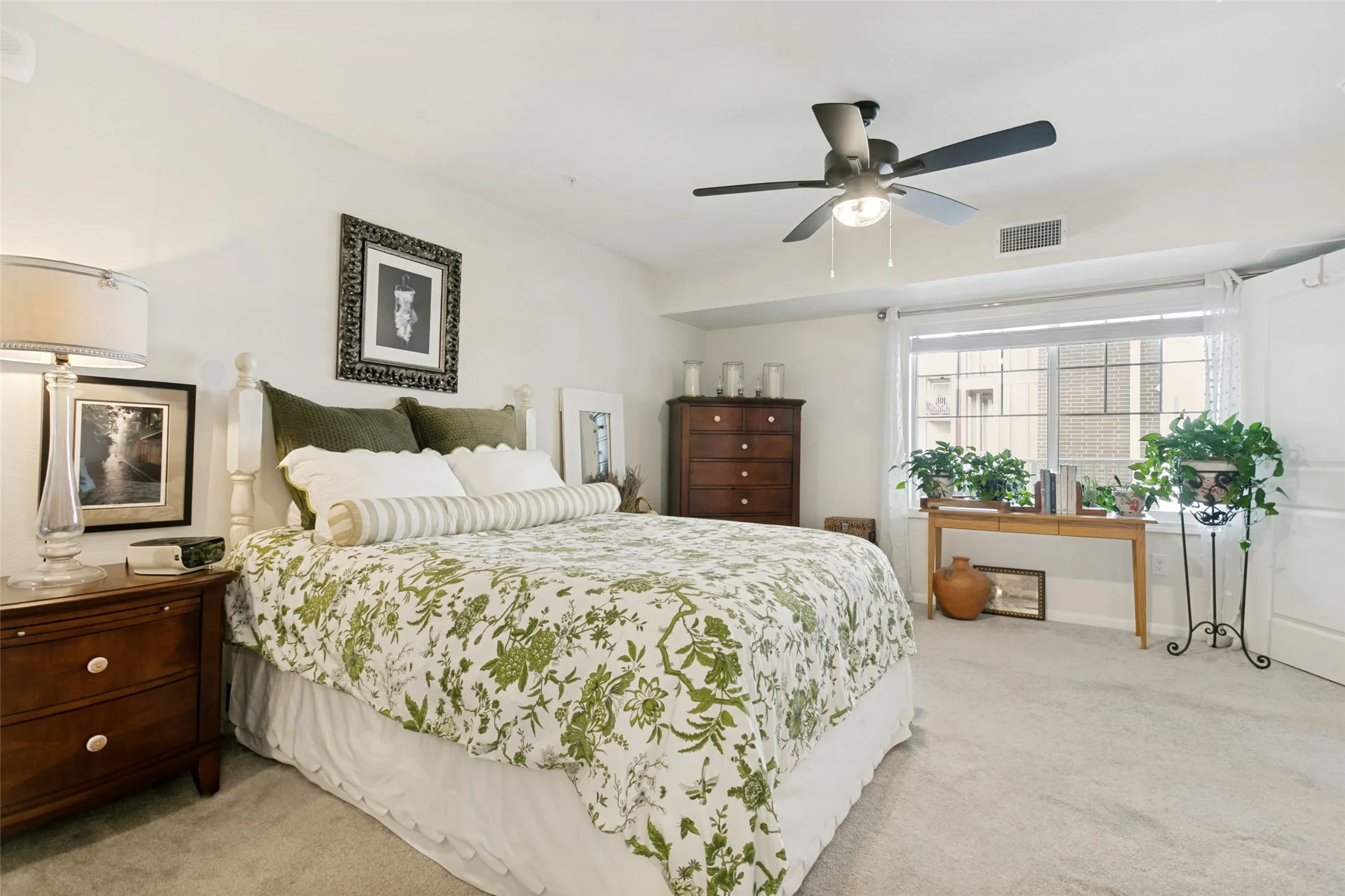 The primary bedroom is filled with natural light.