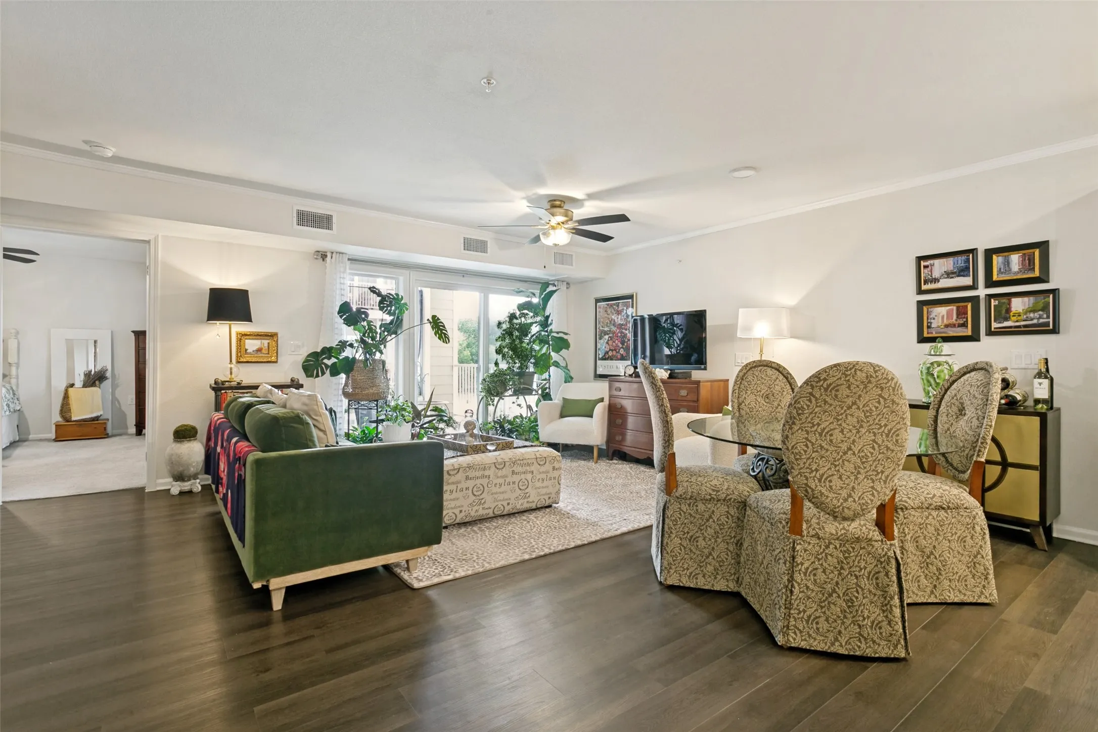 Living space features luxury vinyl flooring, decorative ceiling fan and steps out onto your private balcony.