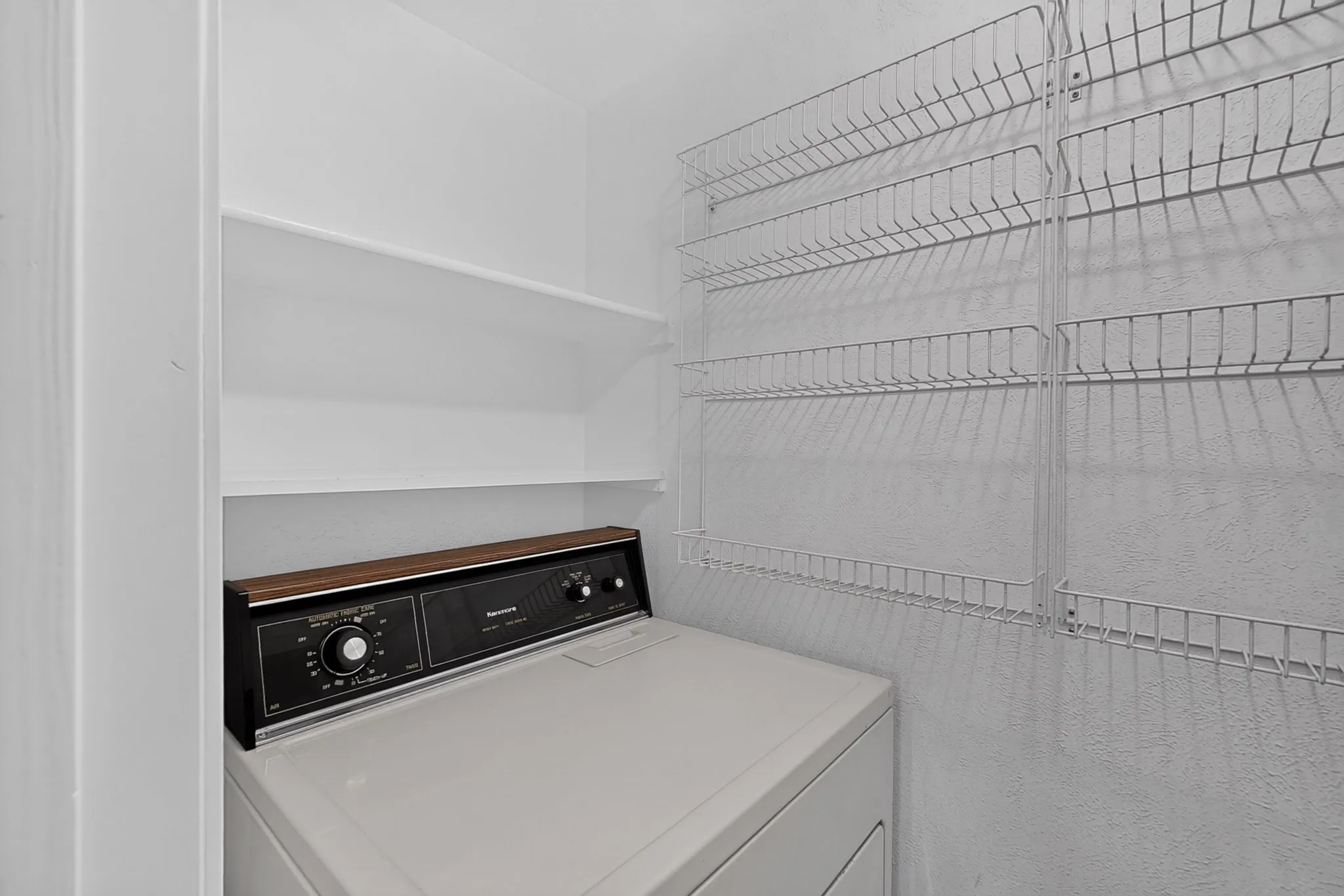 Laundry off kitchen features space for full sized electric washer and dryer