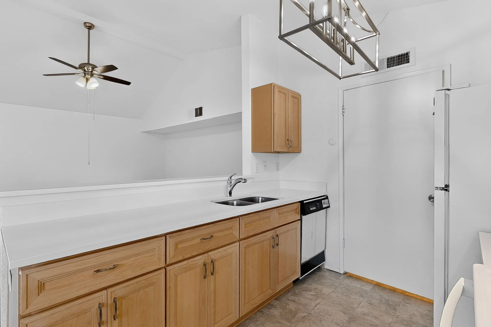 Kitchen features lots of cabinets and a double sink