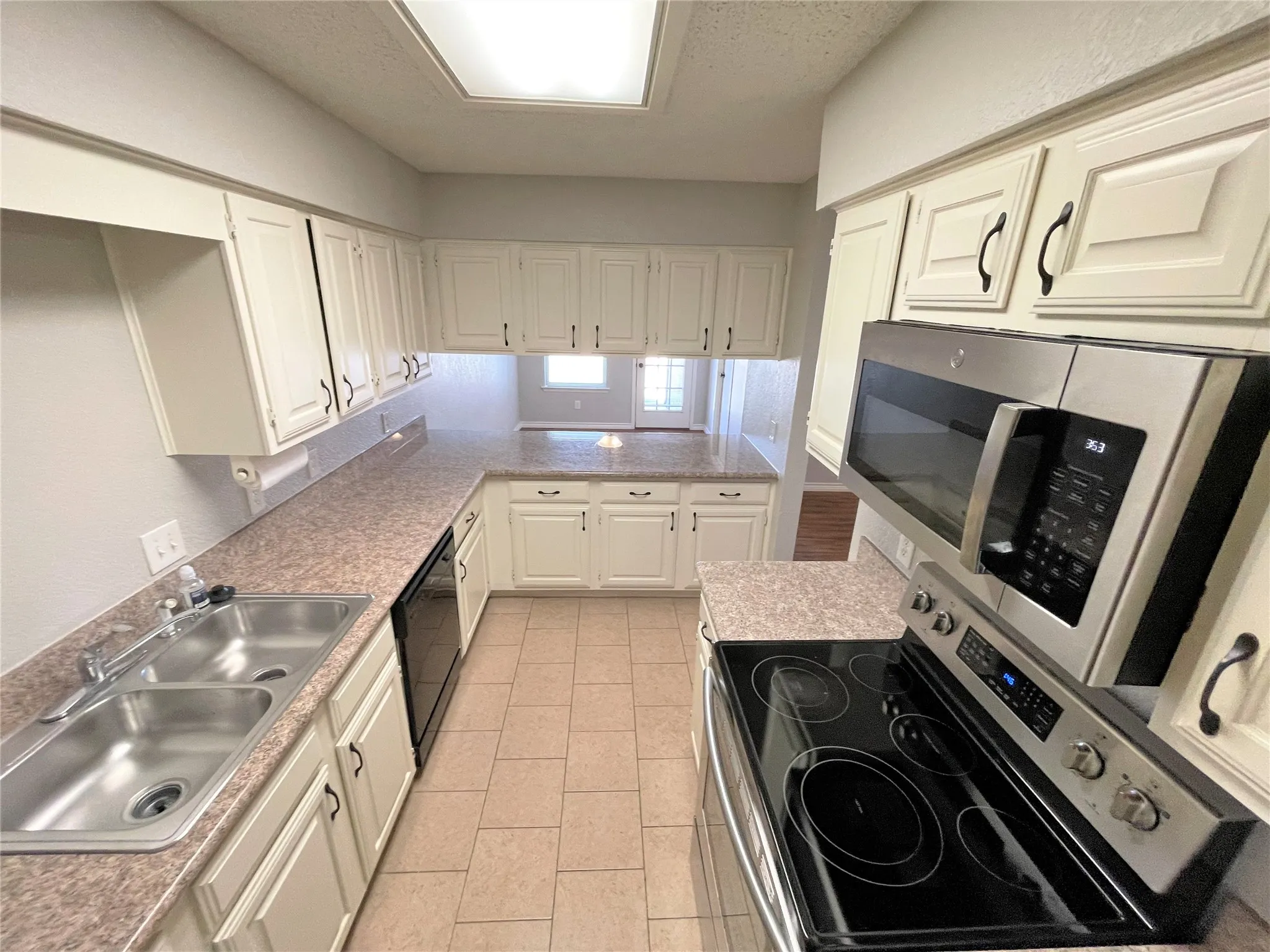 Freshly painted kitchen with stainless appliances. Fridge included.