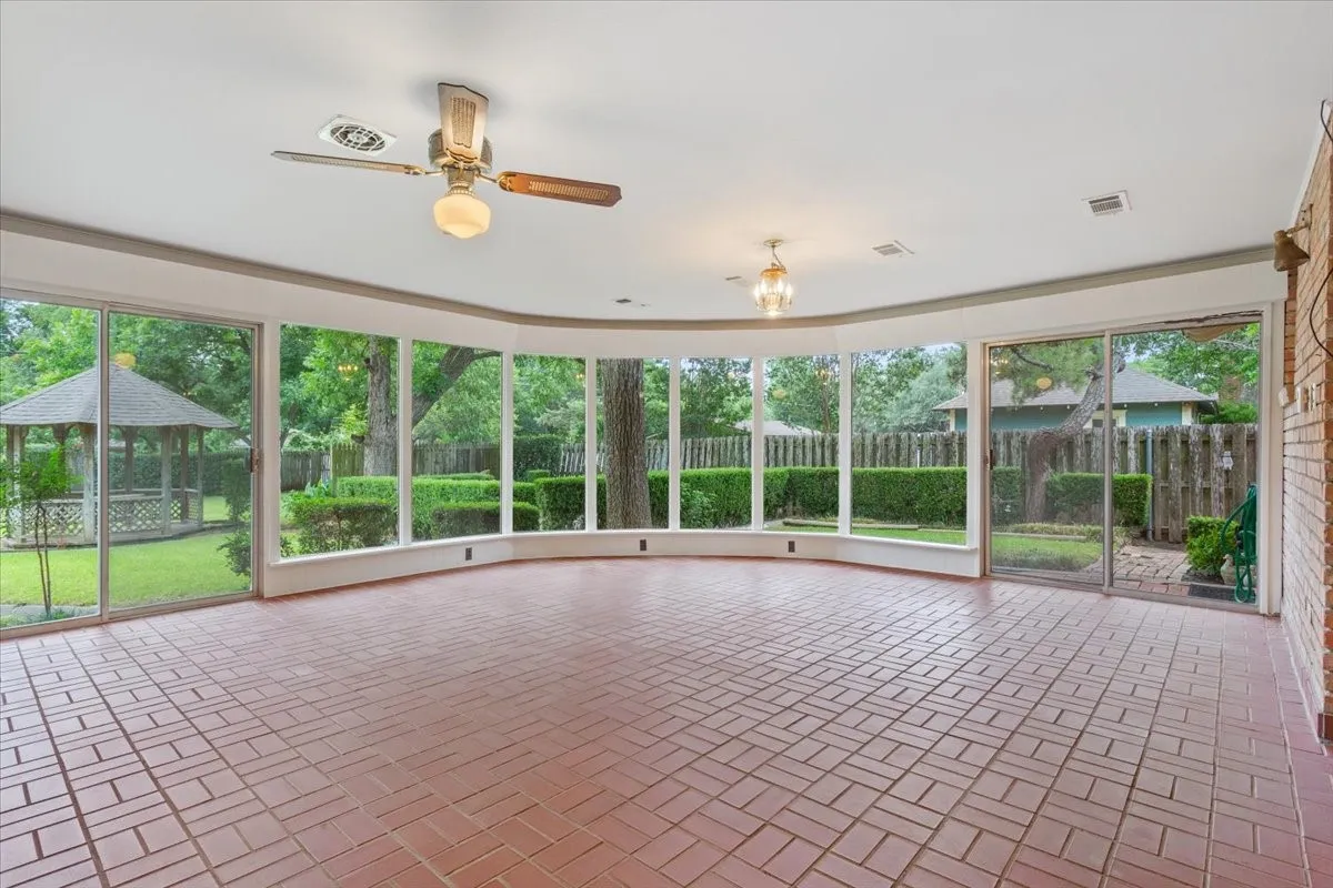 Glass windows of sun room with view of Gazebo and back yard