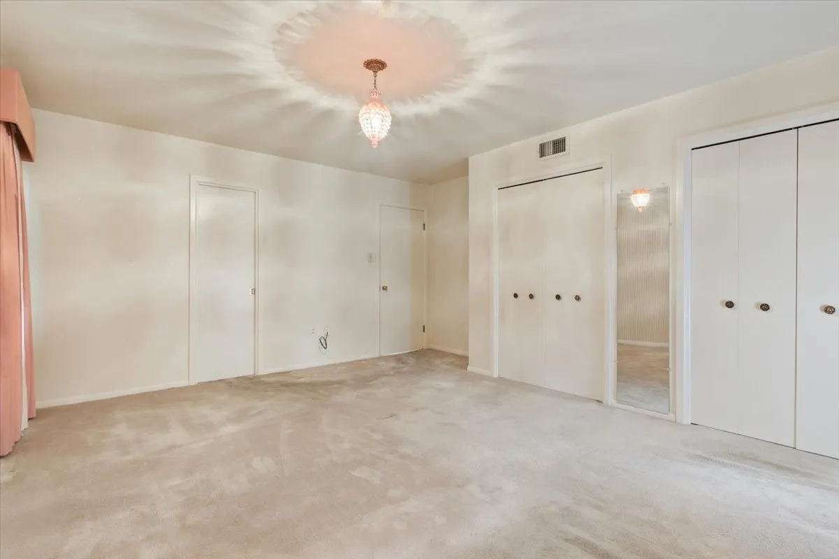 Primary bedroom with his and her closets