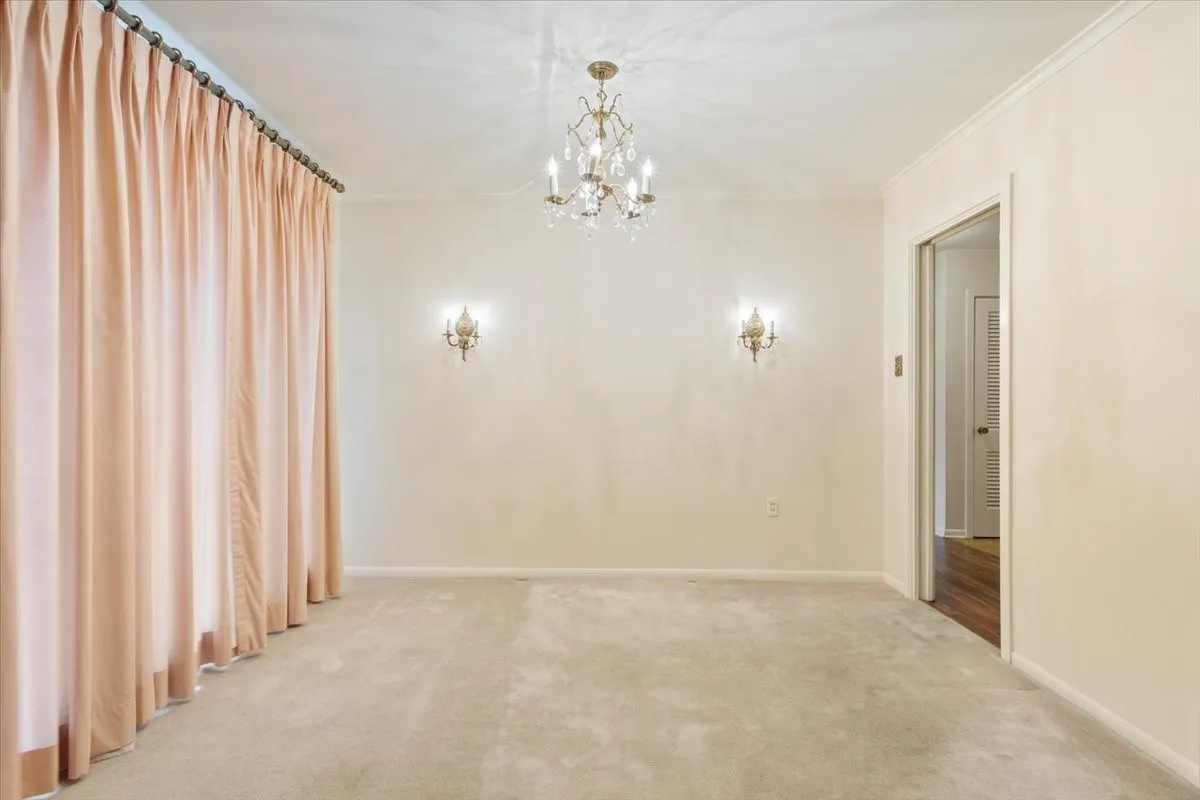 Large open dining area with original light fixtures and entry to kitchen