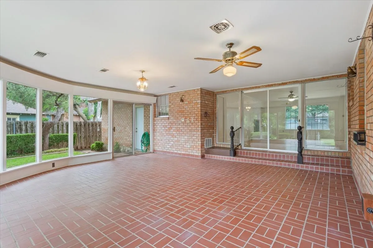 Large sun room perfect for entertaining with view of back yard and den