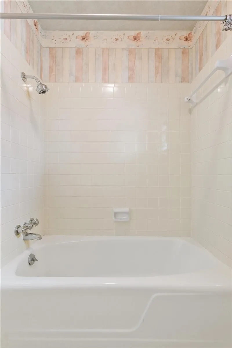 Second bathroom with tub/shower combo with original tile