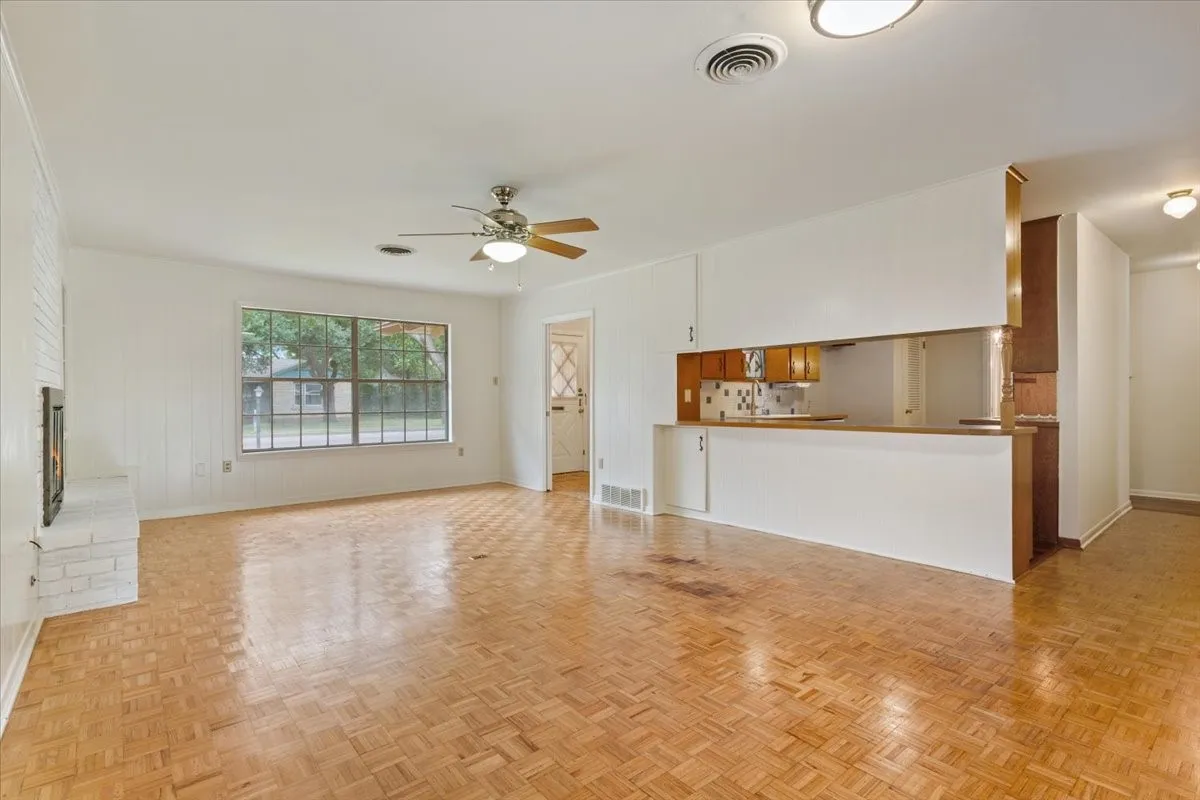 Living room with view of front entry and kitchen
