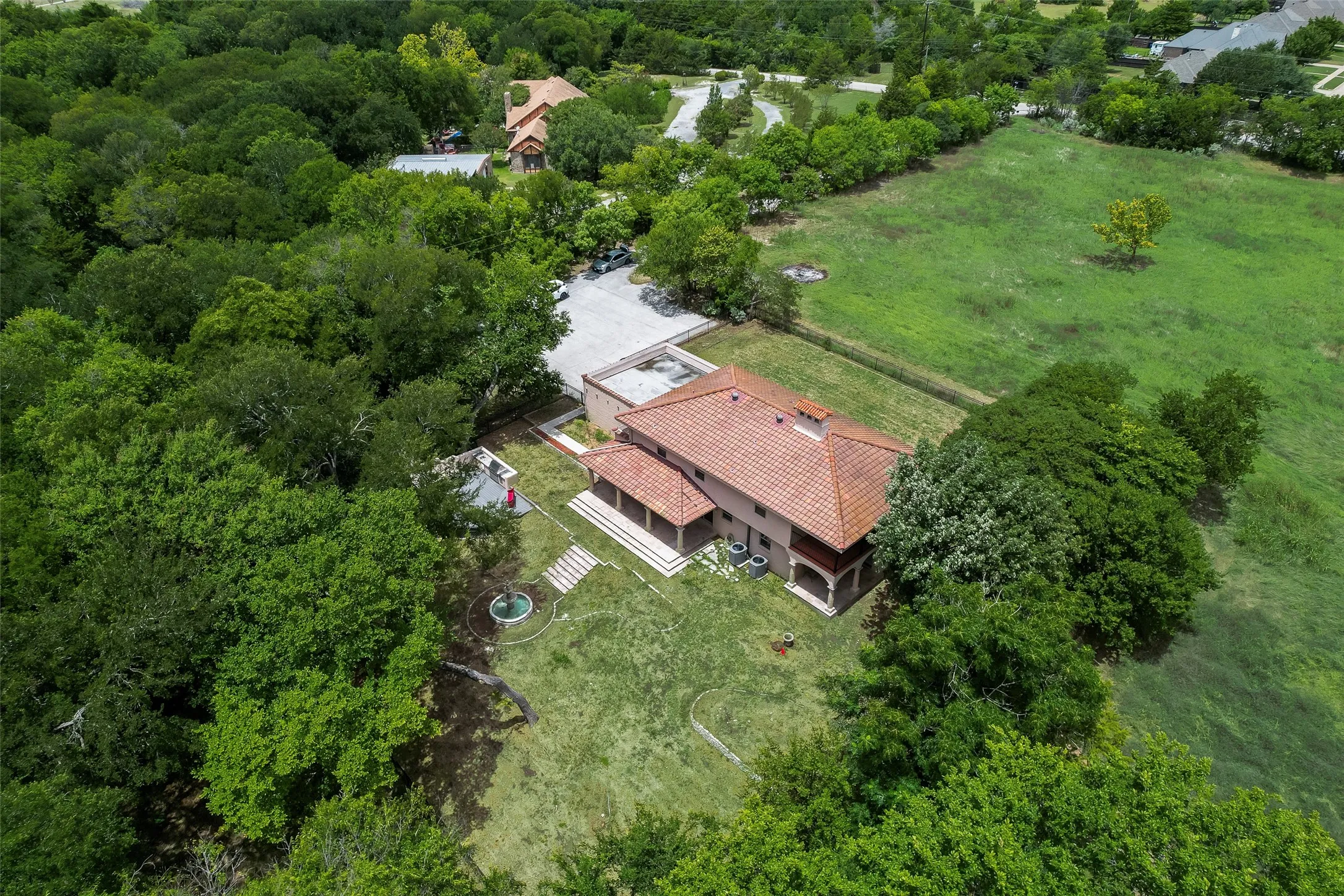 Back view of home and large front yard.