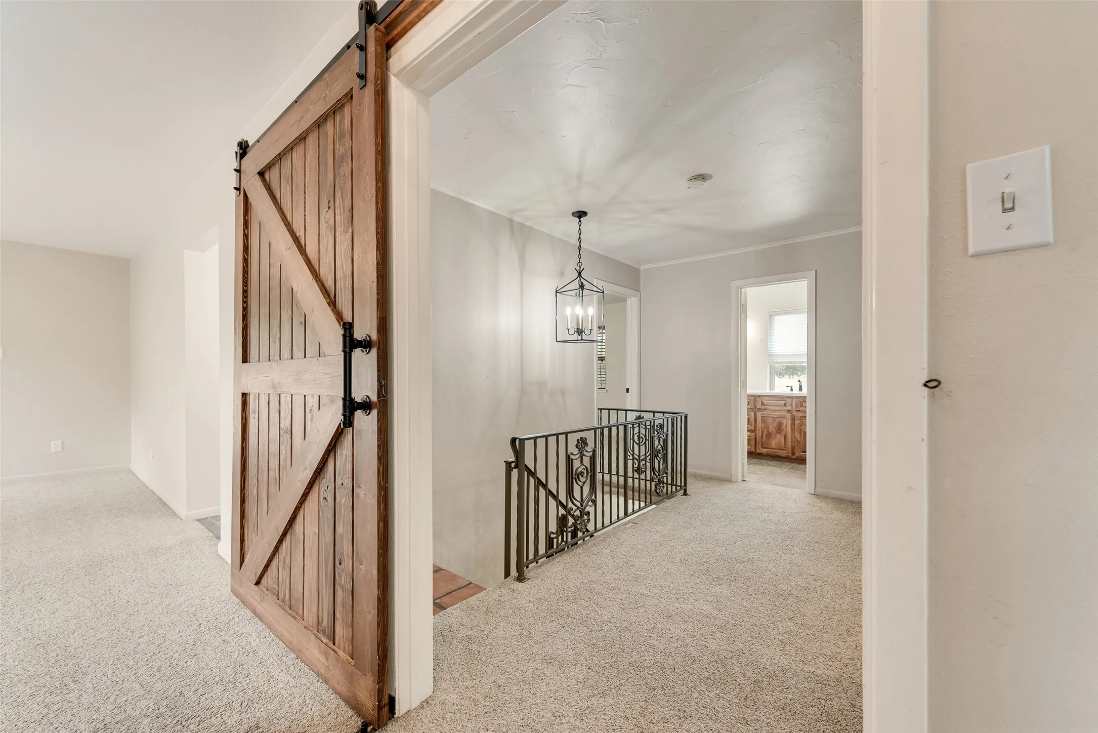 Barn doors that separate primary bedroom from other rooms upstairs