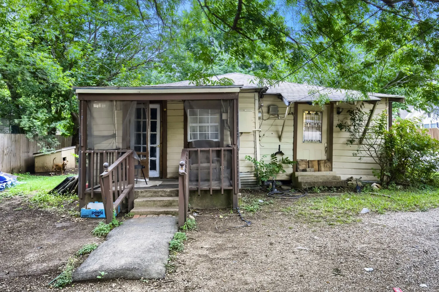Exterior with siding, screened porch, wood railings, and a concrete entry path