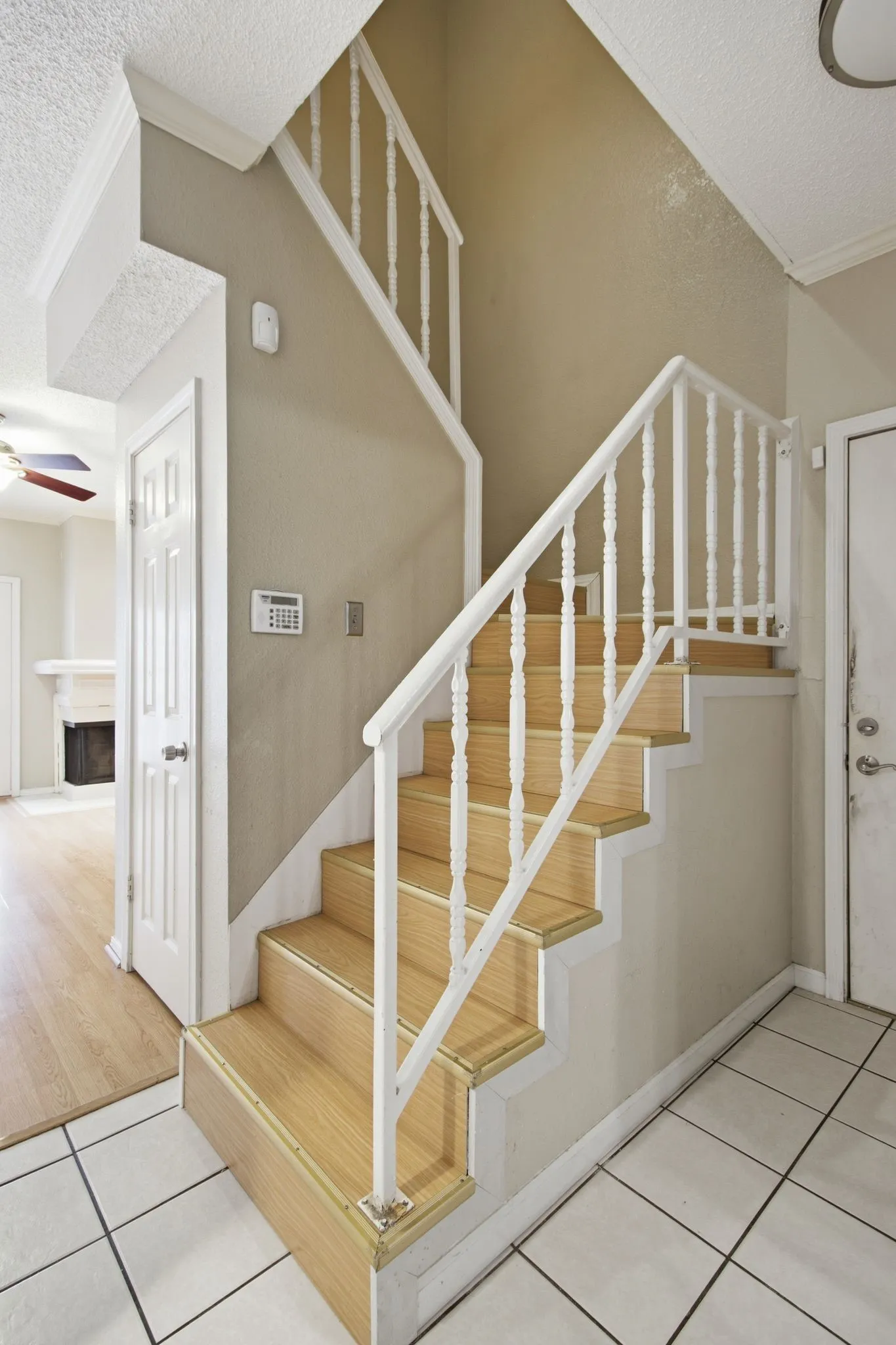 Multi-level staircase with wood-finish treads and white balusters