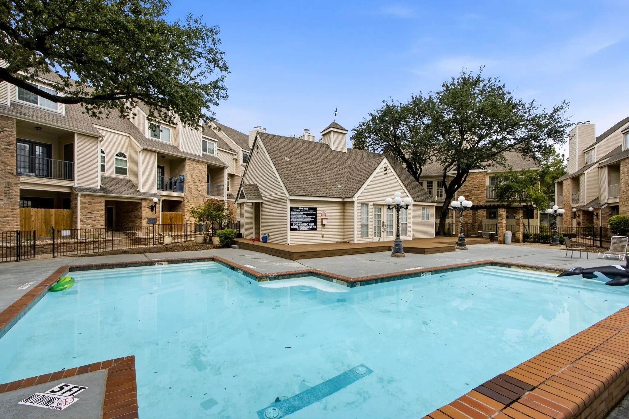 Outdoor swimming pool with integrated steps and a surrounding brick coping