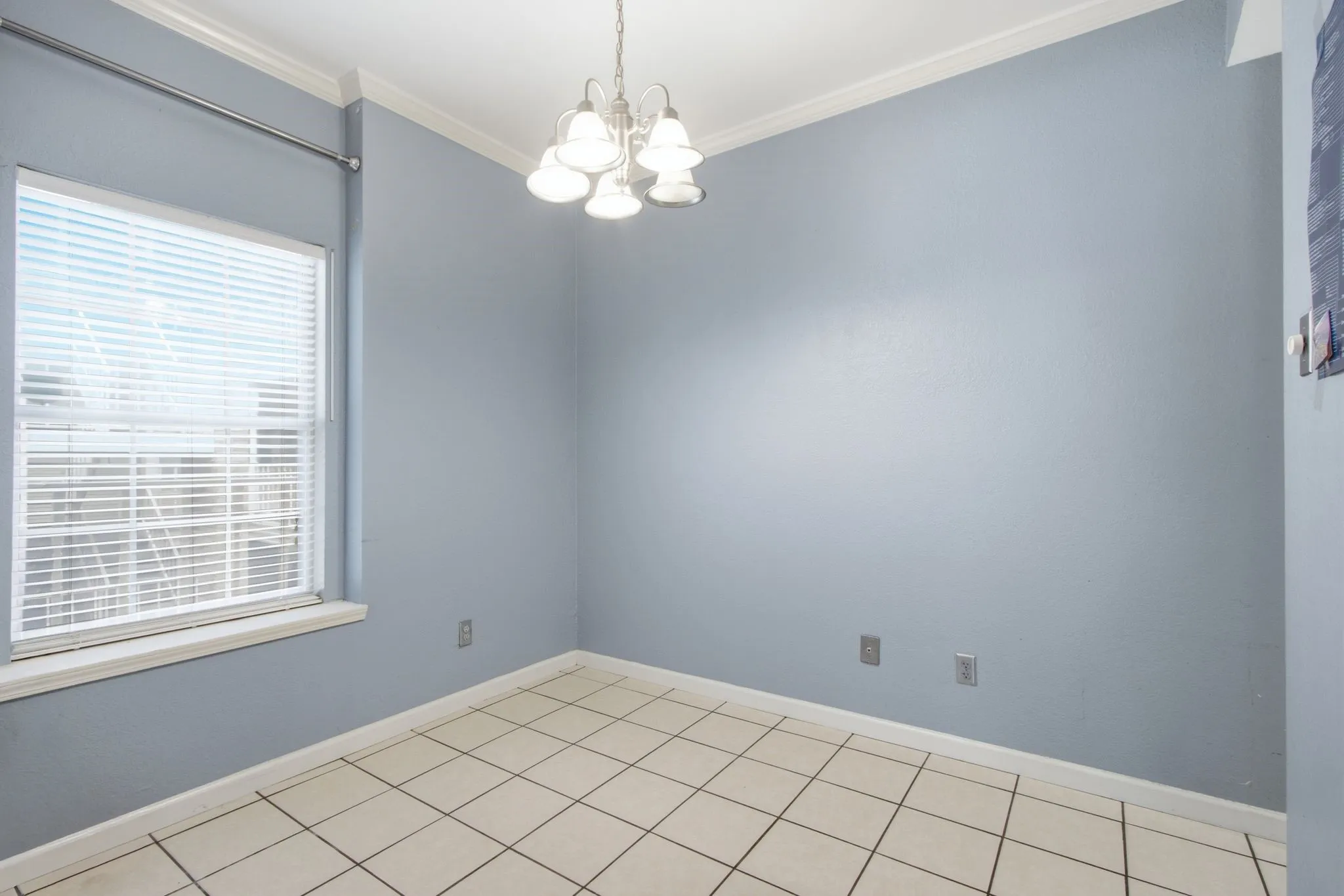 Square tile flooring with light blue walls and white trim
