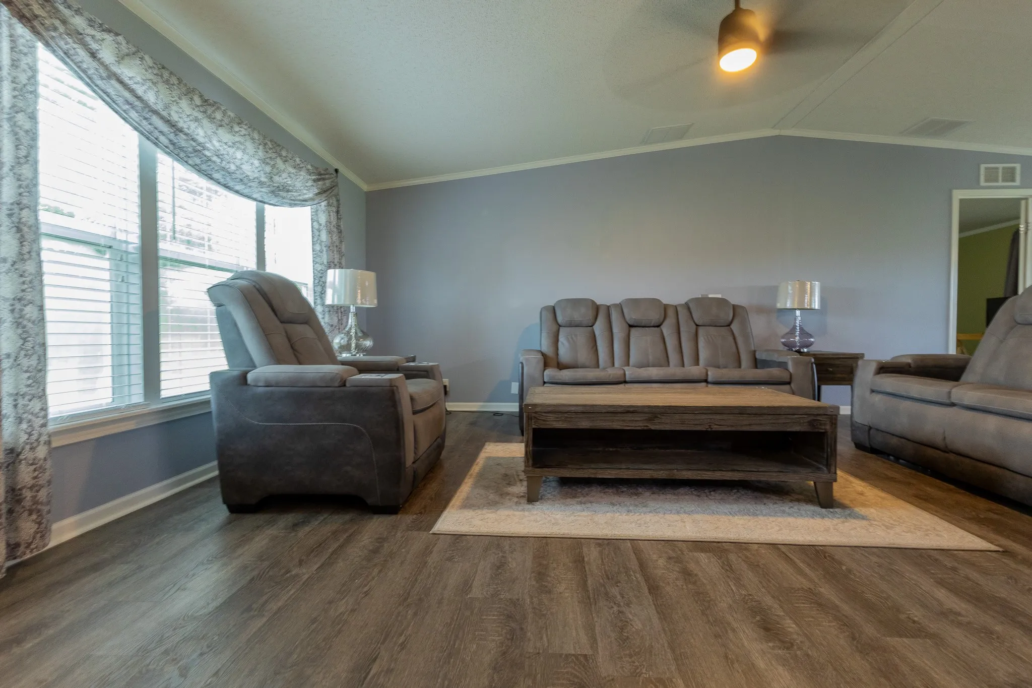 Spacious interior with wood-finish flooring and light blue wall color
