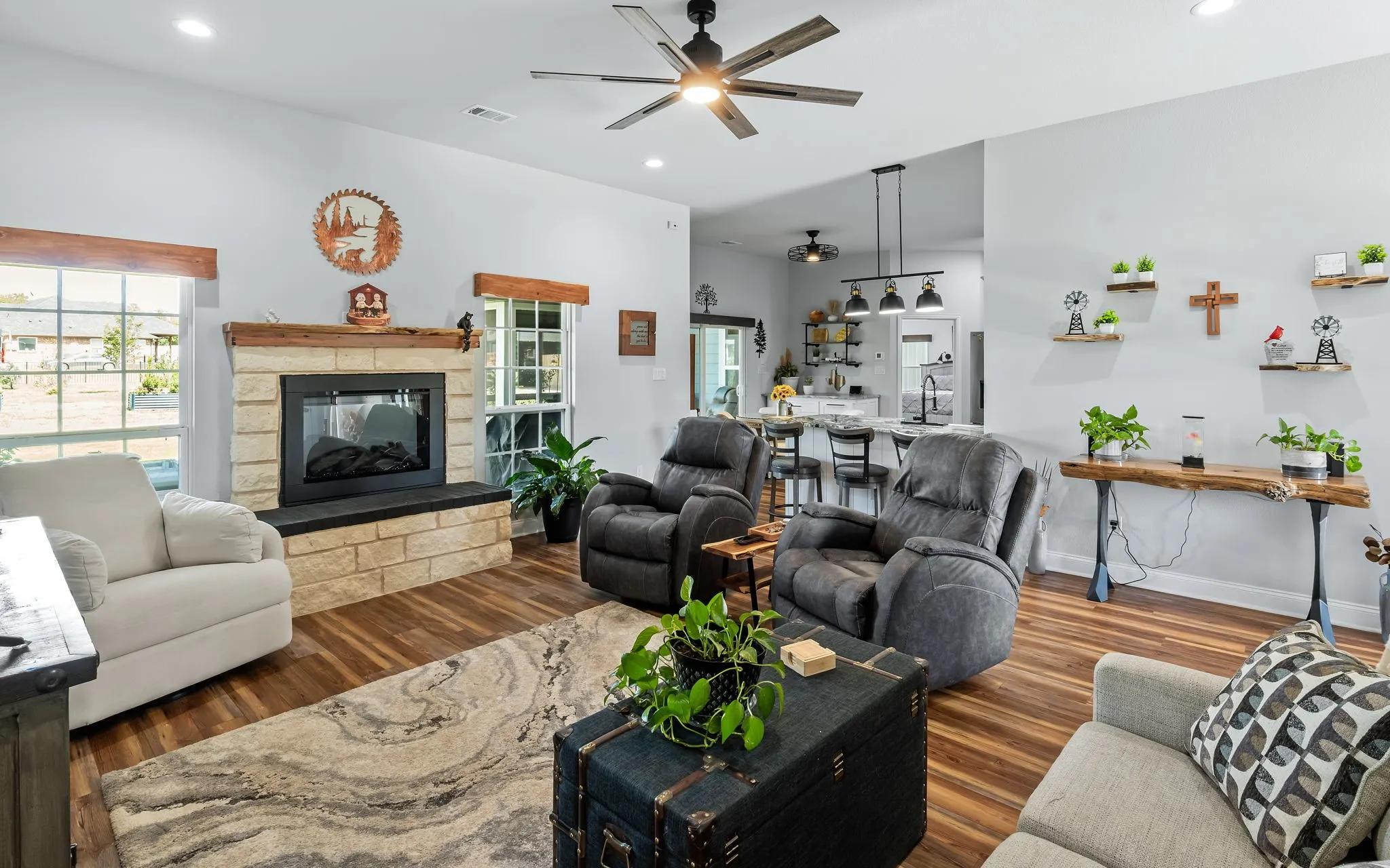 Living area featuring stone-surround fireplace with a wood mantel