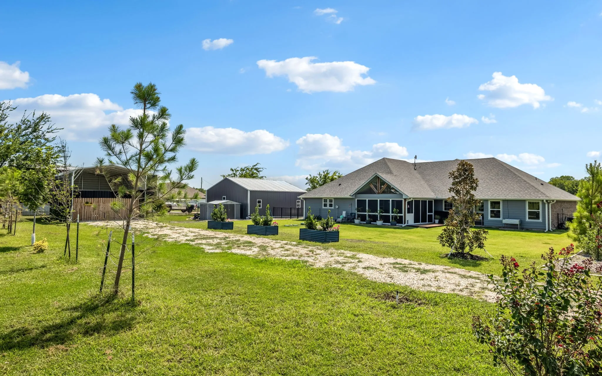 Back view of home, outbuilding and Covered RV parking