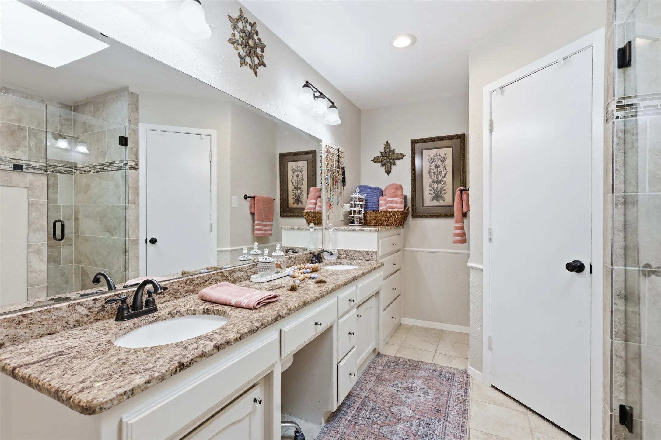 Double vanity with stone countertop and undermount sinks