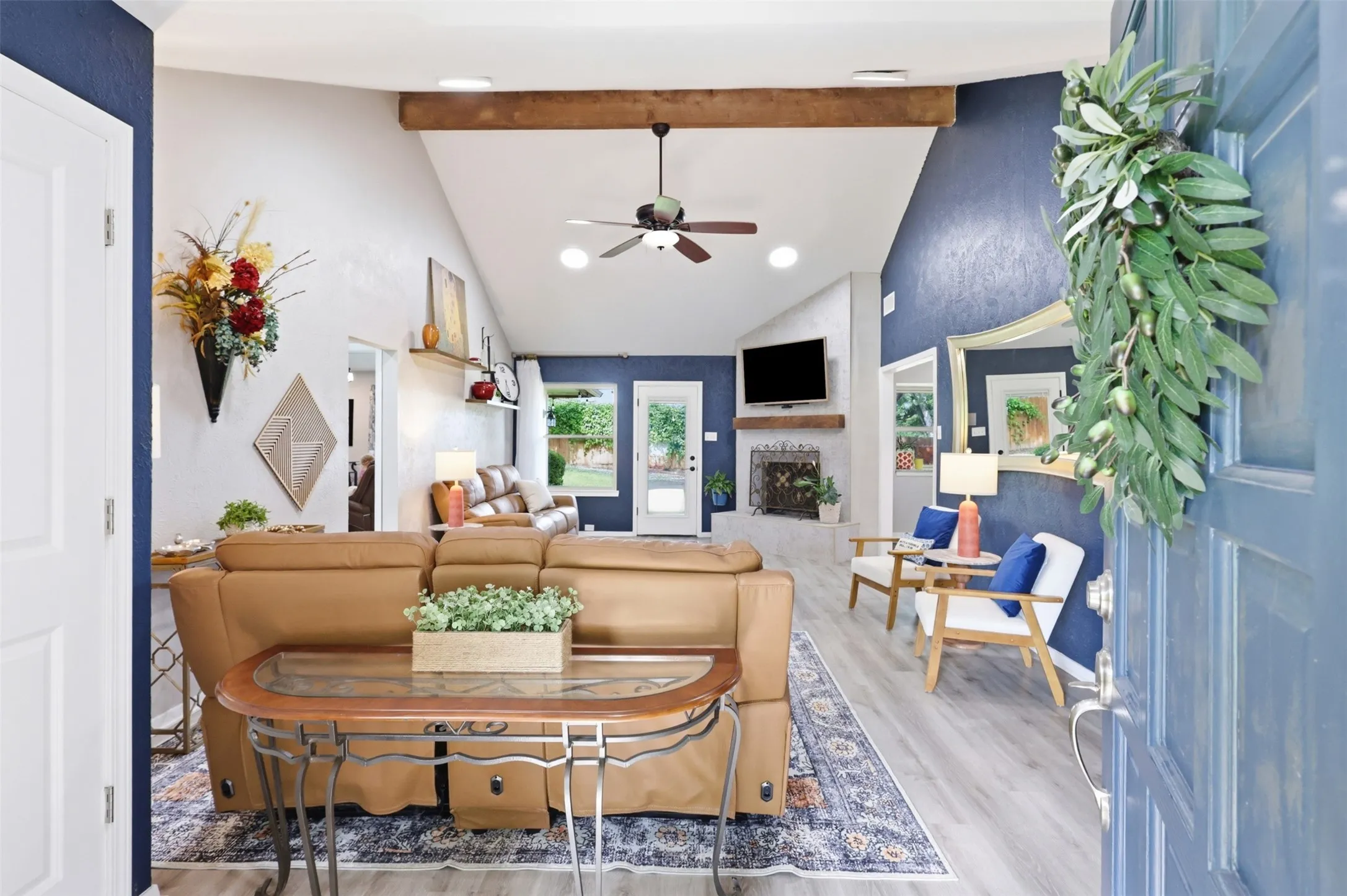 Vaulted ceiling with exposed wood beam and ceiling fan