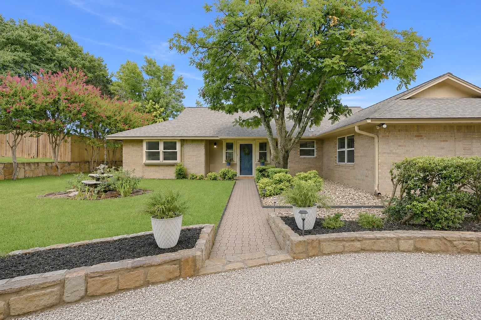 Brick exterior featuring a gabled roof and a paved walkway