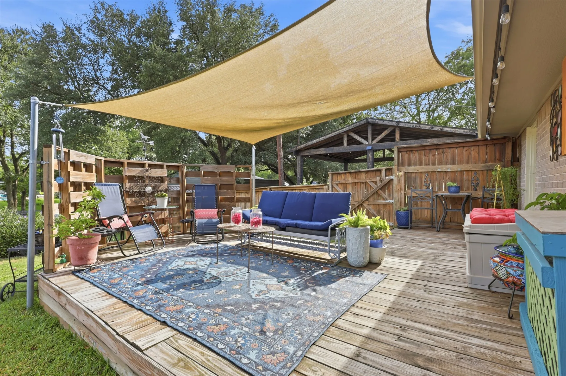 Expansive outdoor deck featuring wood flooring and a shade sail