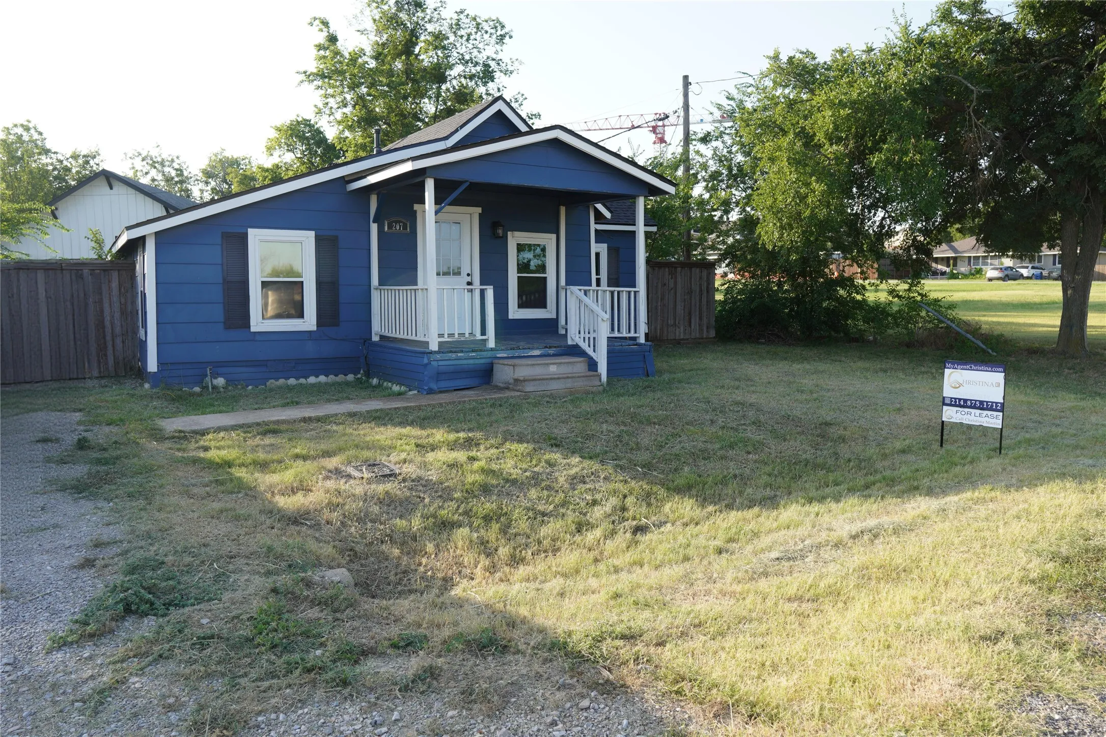 Blue siding exterior with a covered porch and white railings