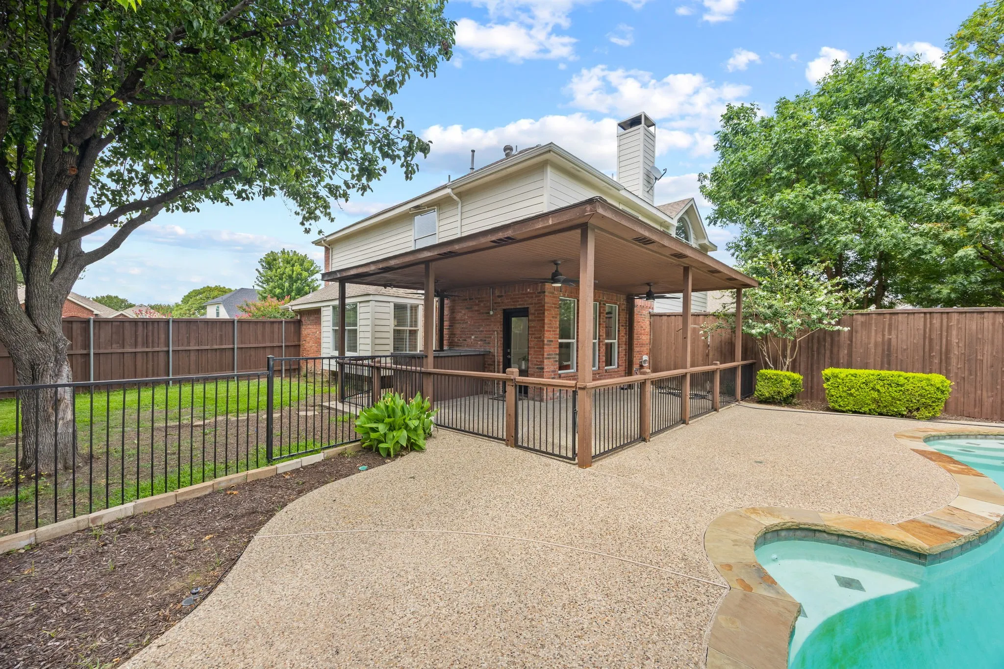 Pool is fenced and yard offers large play area