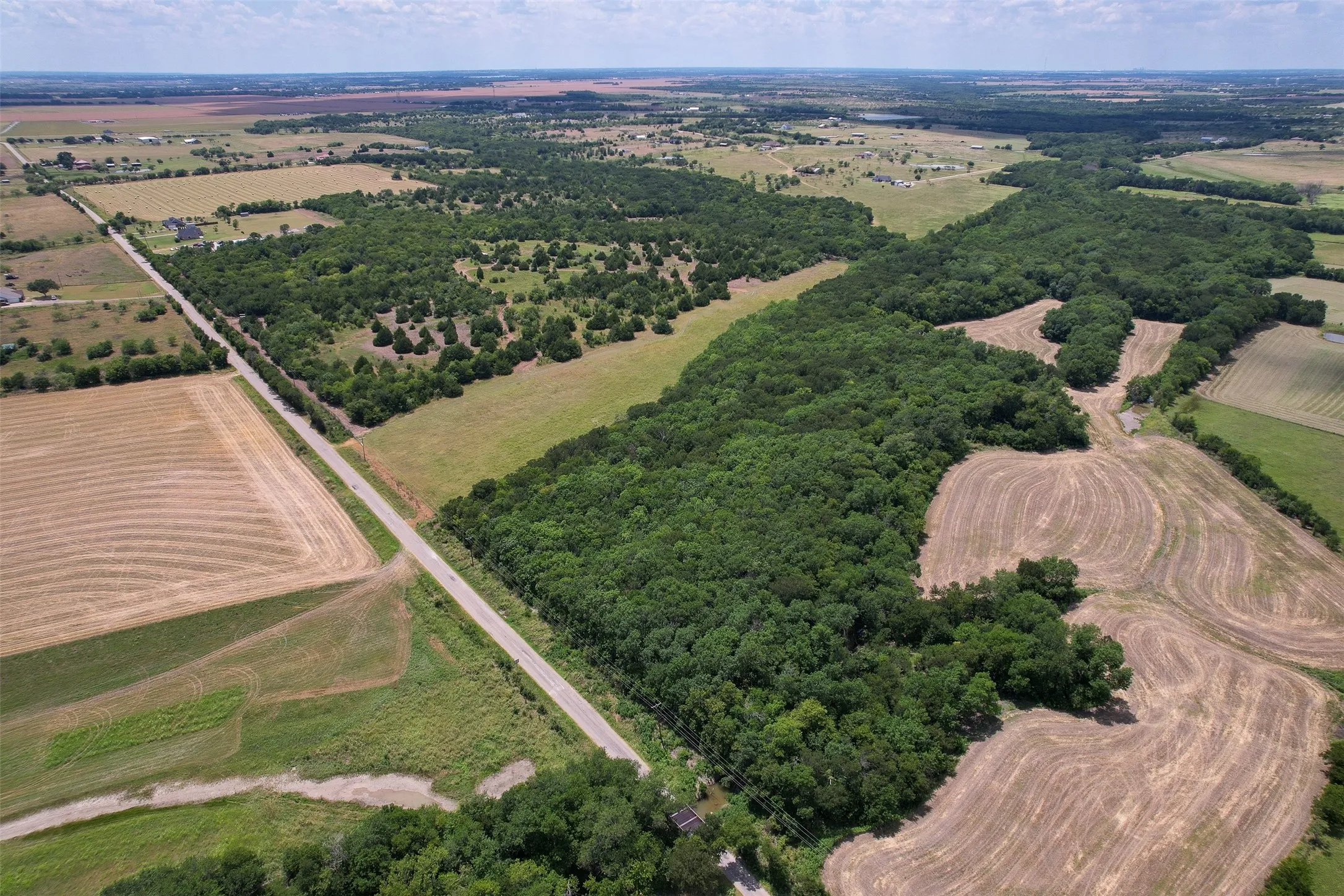 Expansive acreage featuring significant tree cover and open fields