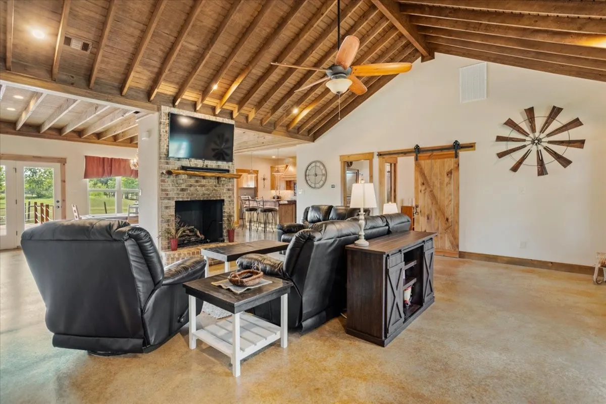 Vaulted wood-beam ceilings complement the stained concrete flooring