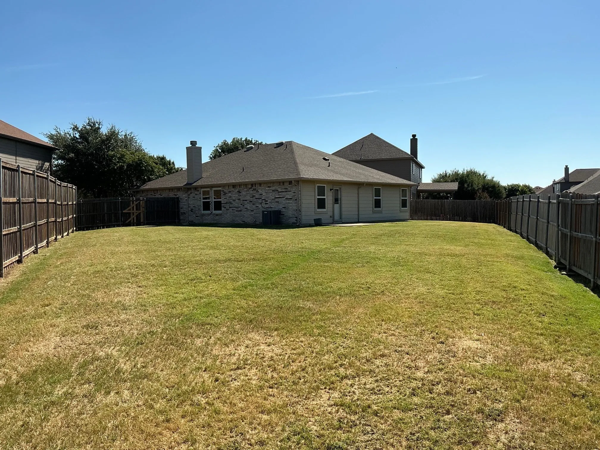 Large back yard is big enough for practicing your soccer moves or catching skills