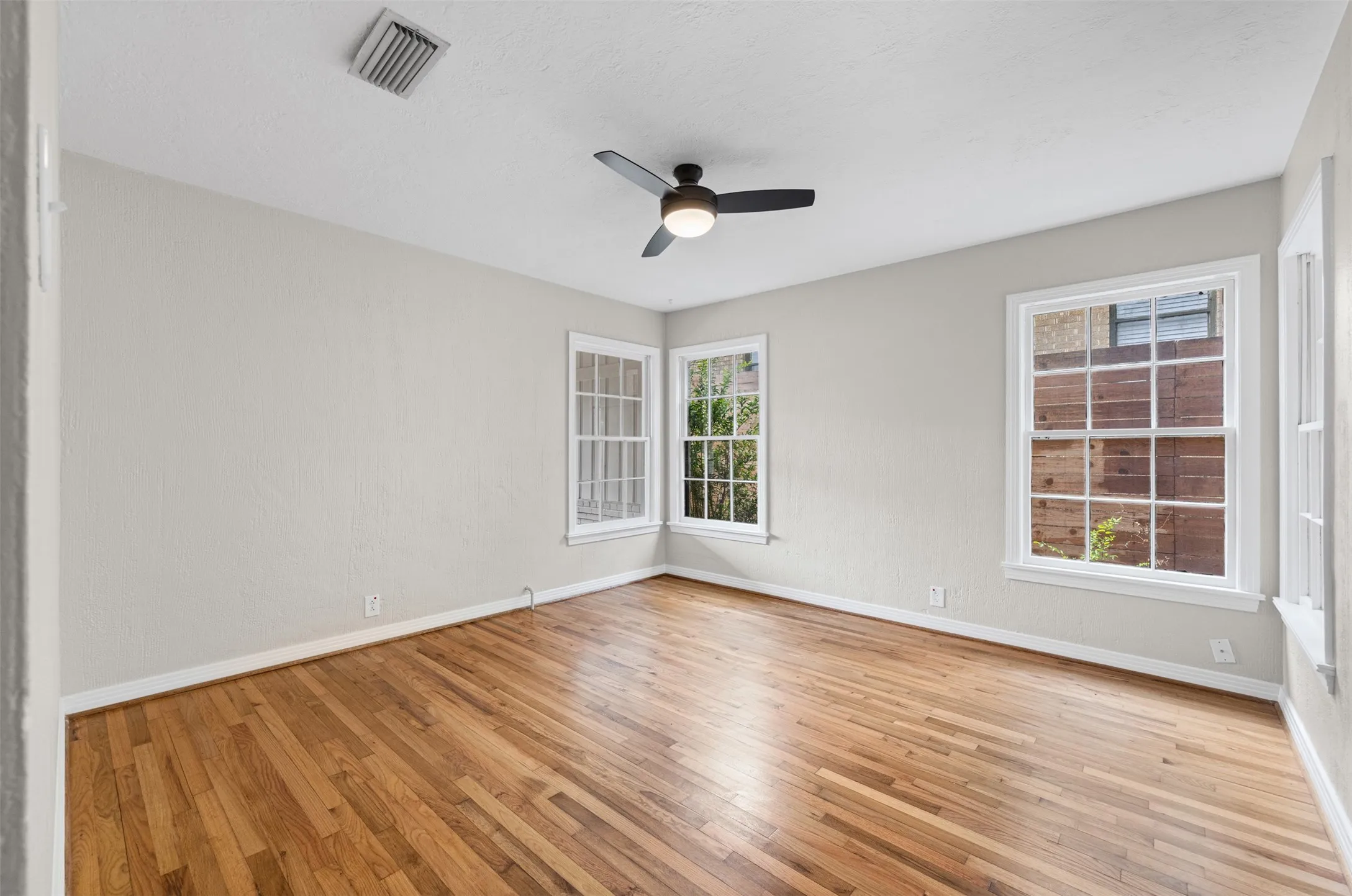 Bedroom with hardwoods and ceiling fan