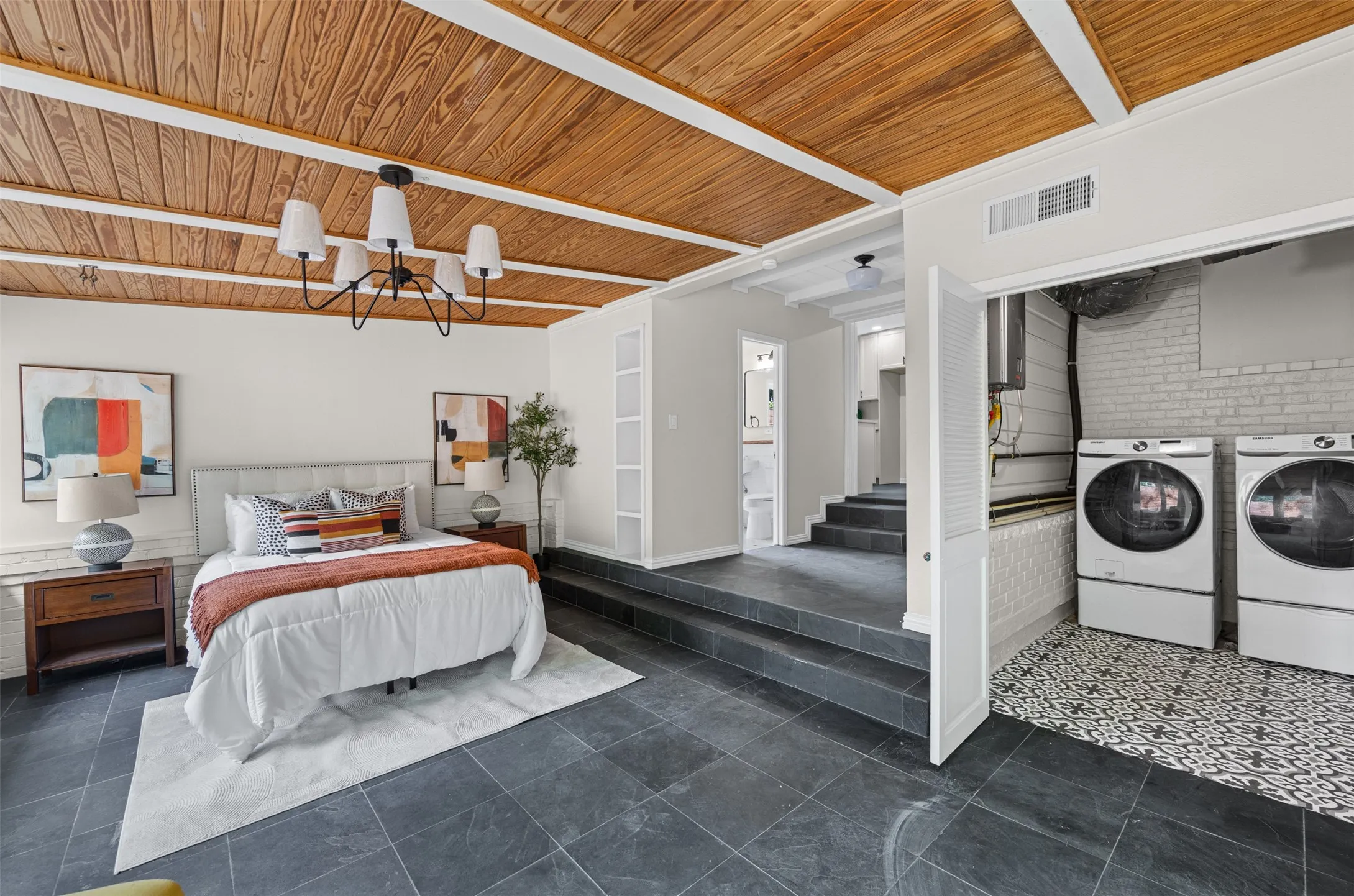 Bedroom with laundry. This room has sliding doors leading to the back patio