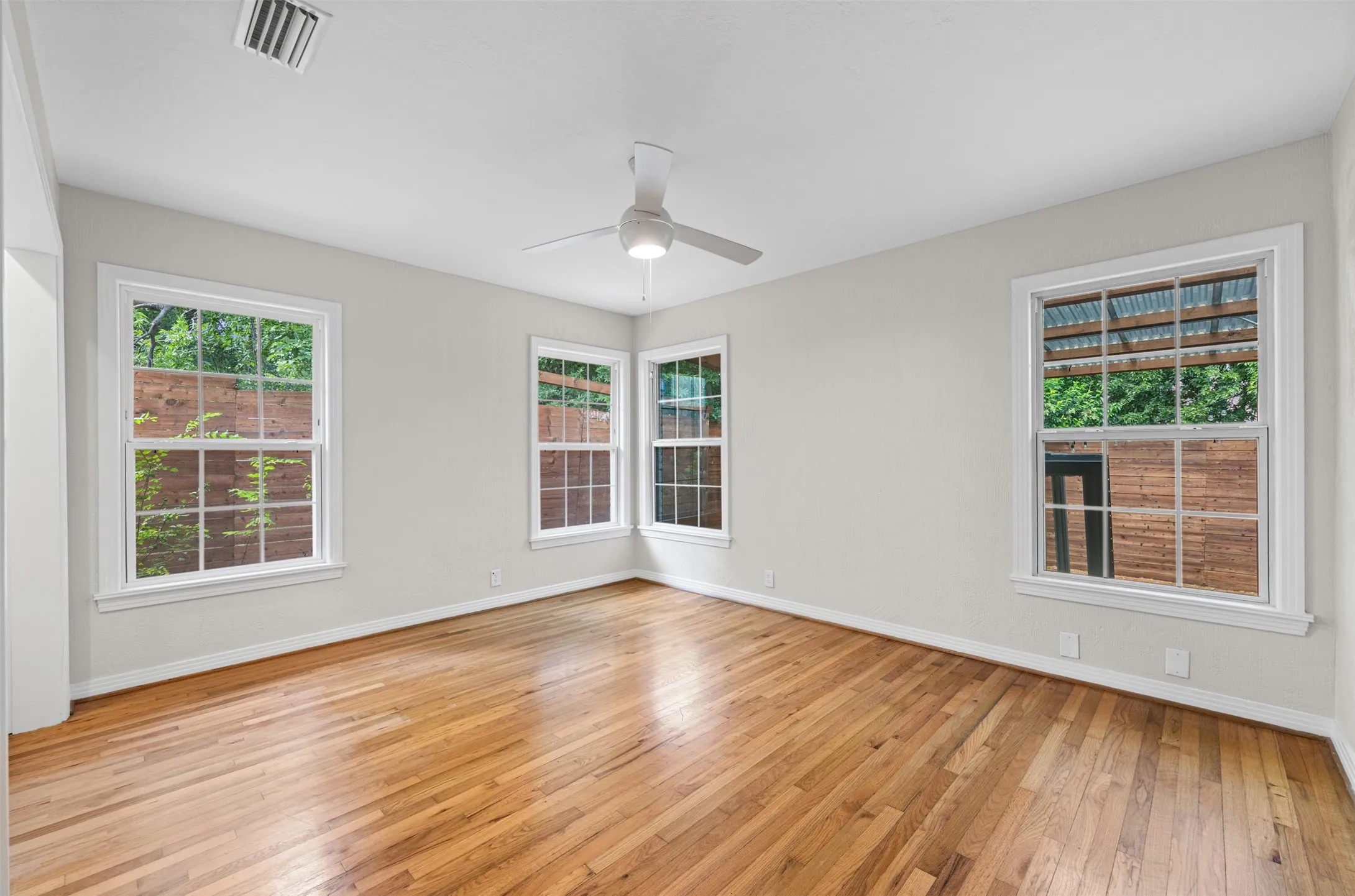 Bedroom with original hardwoods and ceiling fan